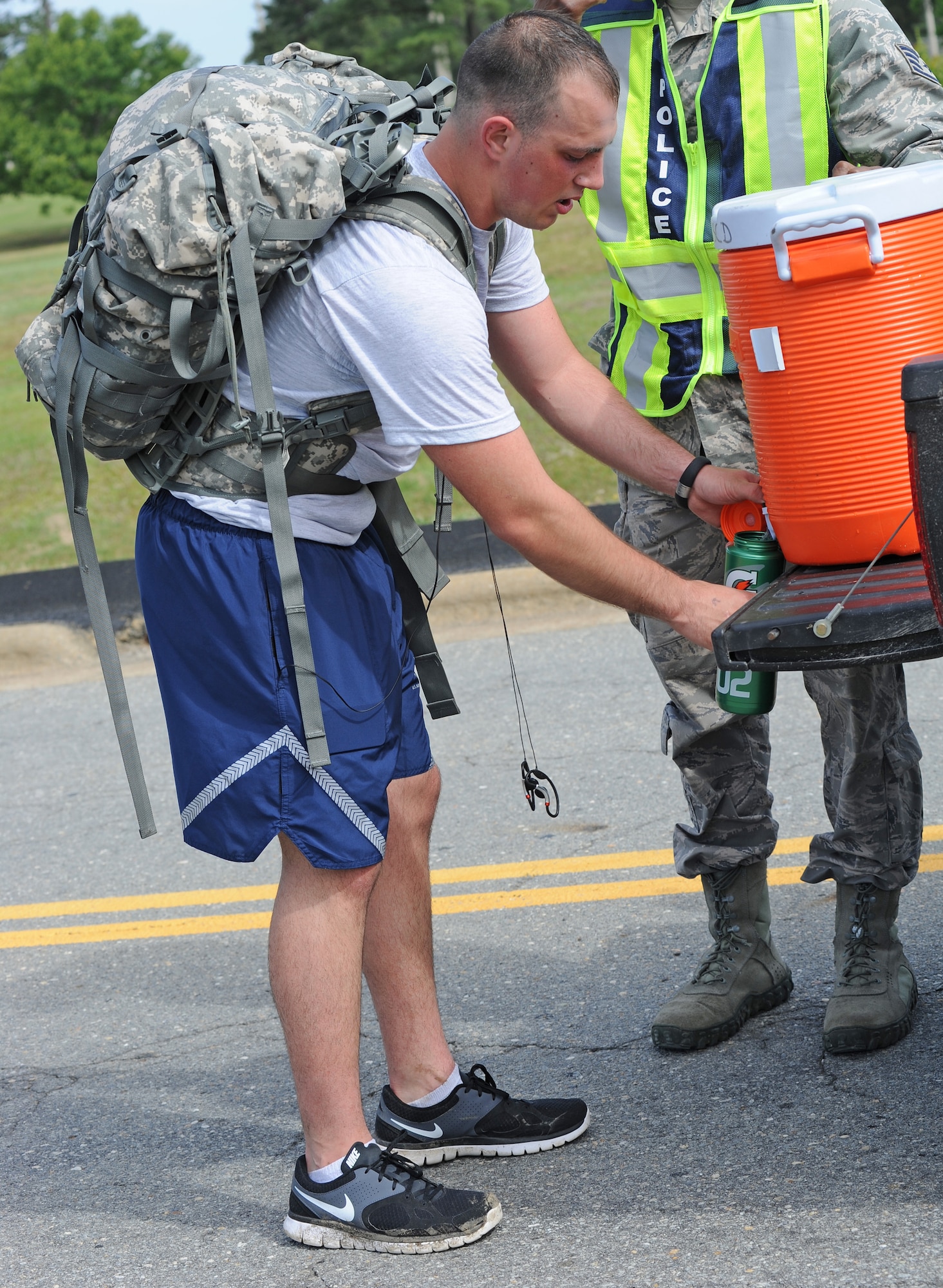 U.S. Air Force Senior Airman Nicholas Shaffer refills his water bottle during a ruck march on Seymour Johnson Air Force Base, N.C., May 14, 2012. Security Forces Airmen marched 6.2 miles in teams of two for National Police Week. Shaffer, 4th SFS patrolman, hails from Elkhart, Ind. (U.S Air Force photo/Senior Airman Gino Reyes/Released)