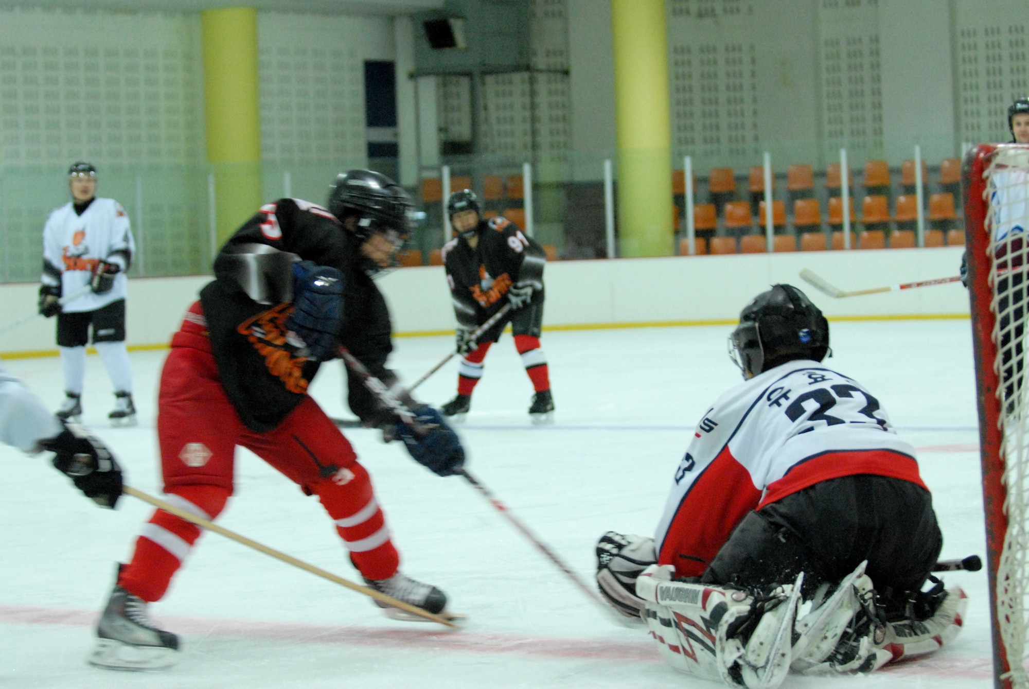 A South Korean hockey goalie blocks an opponent's shot during a scrimmage against Kunsan Air Base Airmen May 13, 2012, in Jeonju, South Korea. Because hockey is a more popular sport in the United States, the Airmen get the chance to share their skills and help their teammates improve. (U.S. Air Force photo/Senior Airman Brigitte N. Brantley)