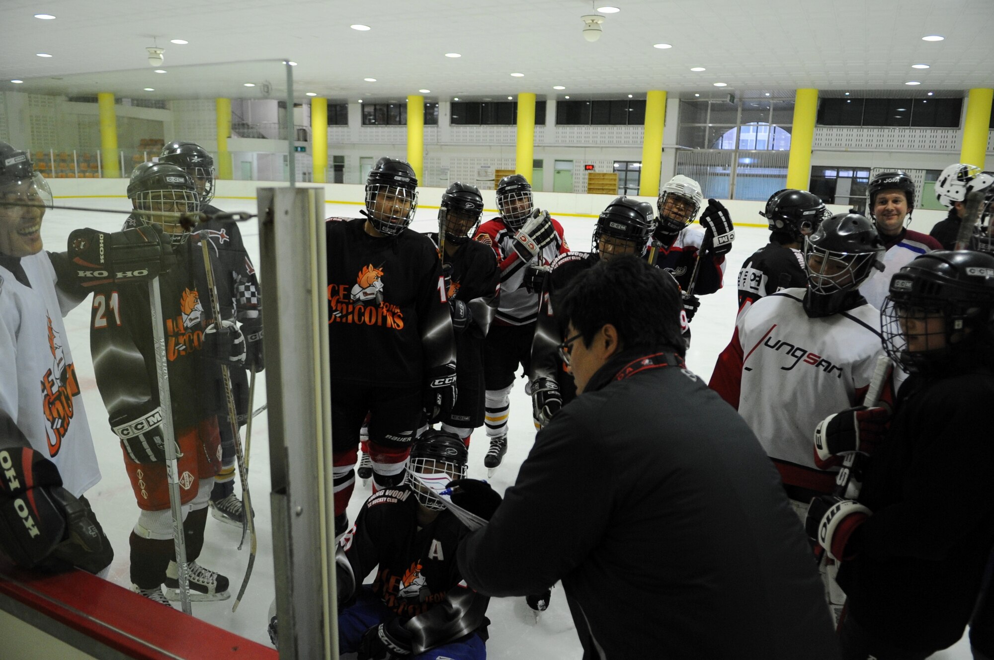 Airmen from Kunsan Air Base gather with South Korean and Canadian players to learn plays during a practice session May 13, 2012, in Jeonju, South Korea. Weekly sessions help players keep their skills sharp while also building relationships within the community. (U.S. Air Force photo/Senior Airman Brigitte N. Brantley)