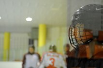 A South Korean hockey player watches for the puck during practice with Airmen from Kunsan Air Base May 13, 2012, in Jeonju, South Korea. Although some Koreans speak English well enough to communicate with the Airmen, much is conveyed through hand gestures. (U.S. Air Force photo/Senior Airman Brigitte N. Brantley)