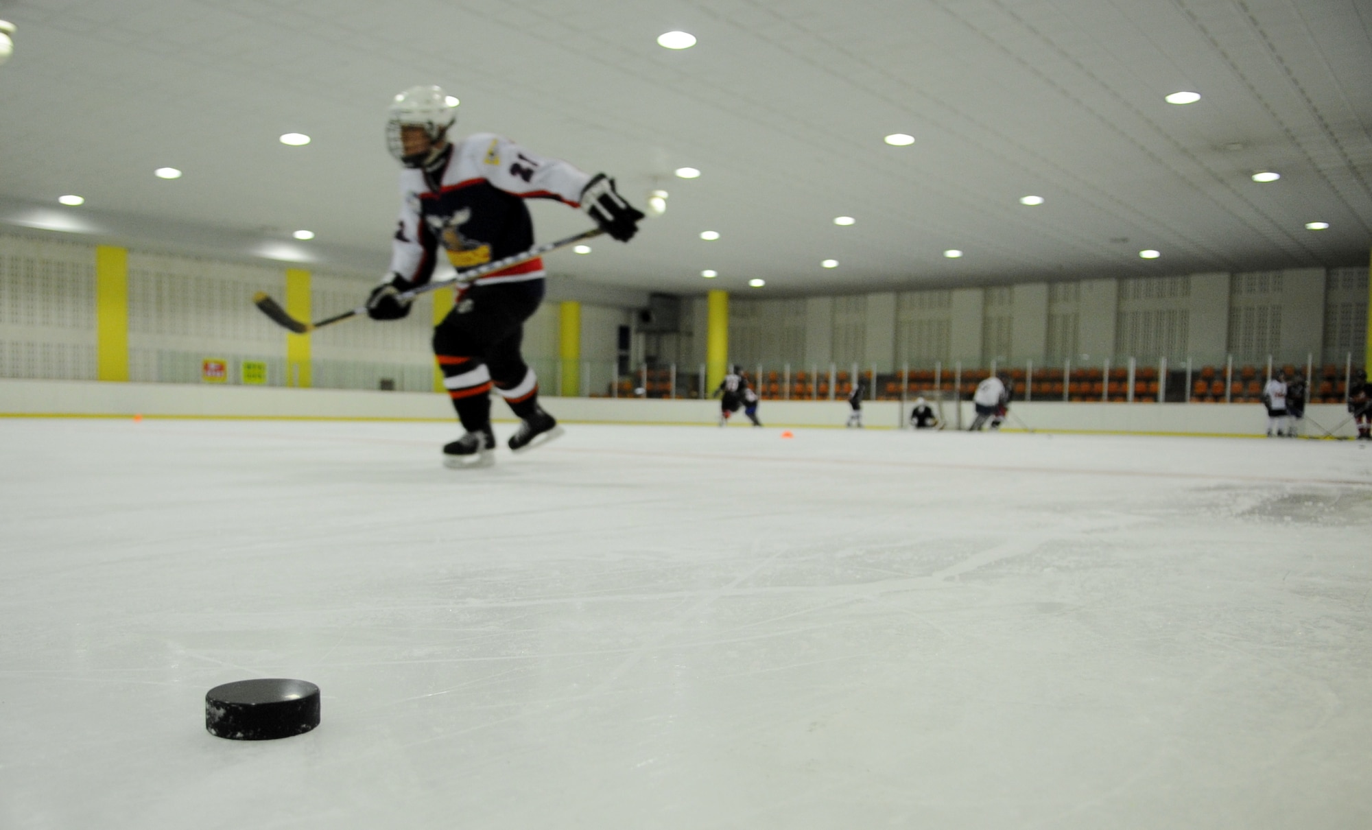 A hockey player speeds to the other side of the rink during practice drills May 13, 2012, in Jeonju, South Korea. Airmen from Kunsan Air Base travel about 45 minutes each weekend to play against South Koreans and keep their hockey skills sharp. (U.S. Air Force photo/Senior Airman Brigitte N. Brantley)