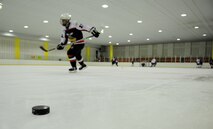 A hockey player speeds to the other side of the rink during practice drills May 13, 2012, in Jeonju, South Korea. Airmen from Kunsan Air Base travel about 45 minutes each weekend to play against South Koreans and keep their hockey skills sharp. (U.S. Air Force photo/Senior Airman Brigitte N. Brantley)