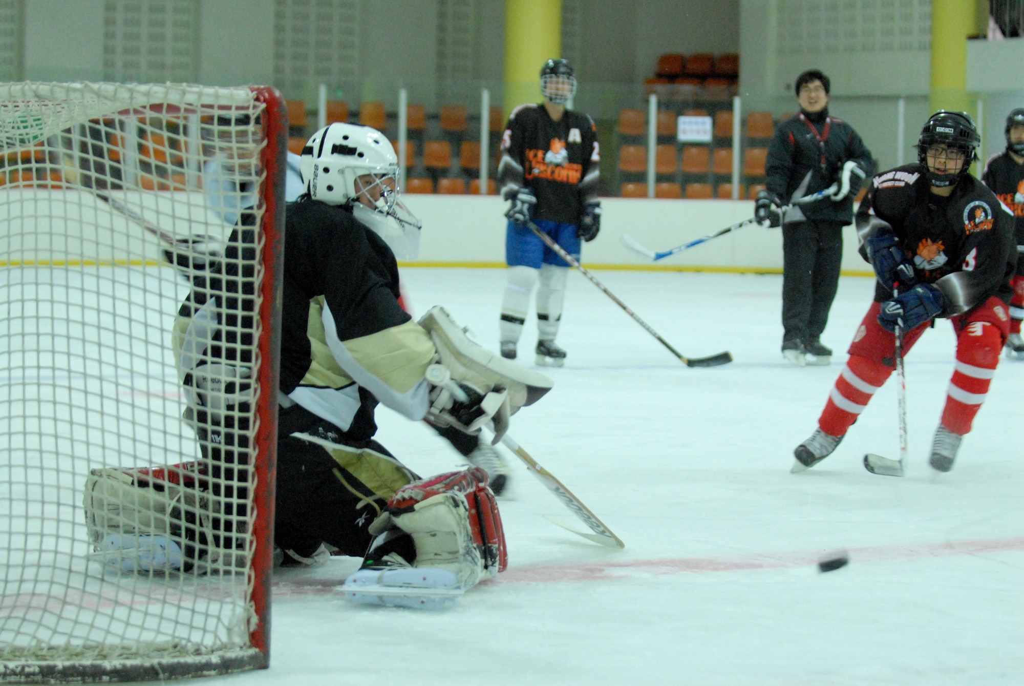 A South Korean hockey goalie braces for an incoming shot during a practice session with Airmen from Kunsan Air Base May 13, 2012, in Jeonju, South Korea. The weekly session helps Koreans and Americans keep their skills sharp while also building community relationships. (U.S. Air Force photo/Senior Airman Brigitte N. Brantley)