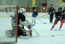 A South Korean hockey goalie braces for an incoming shot during a practice session with Airmen from Kunsan Air Base May 13, 2012, in Jeonju, South Korea. The weekly session helps Koreans and Americans keep their skills sharp while also building community relationships. (U.S. Air Force photo/Senior Airman Brigitte N. Brantley)