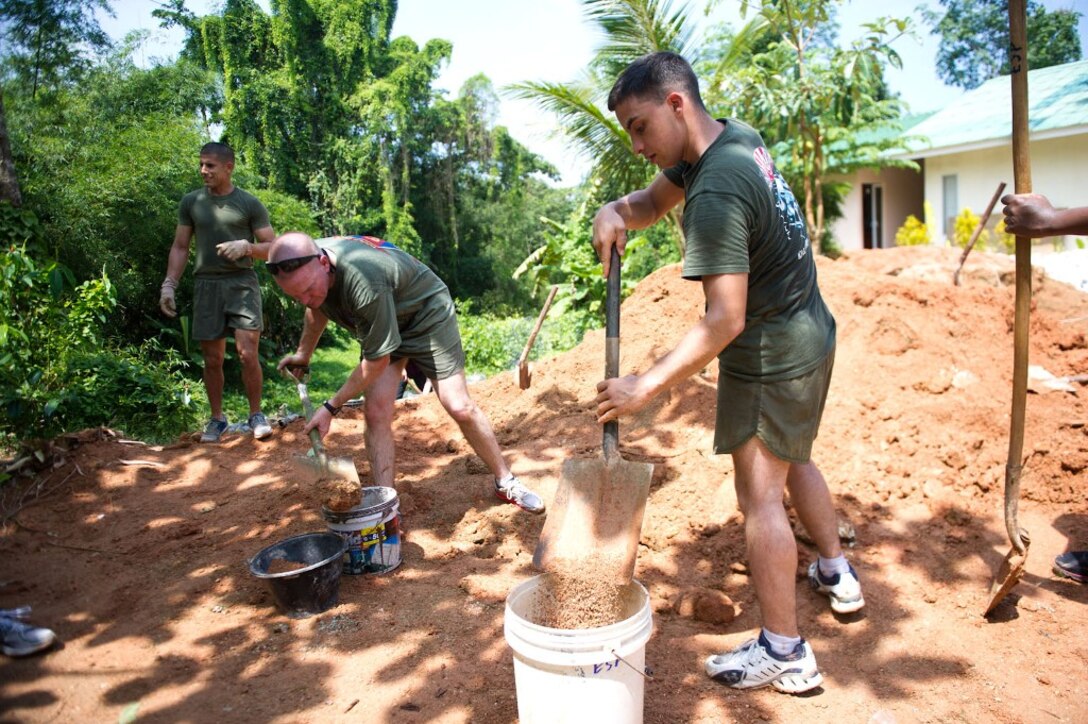 Marines with the 11th Marine Expeditionary Unit shovel dirt during a volunteer project at an orphanage here May 15. The unit embarked the ship, as well as USS Makin Island and USS New Orleans in San Diego Nov. 14, beginning a seven-month deployment to the Western Pacific, Horn of Africa and Middle East regions.