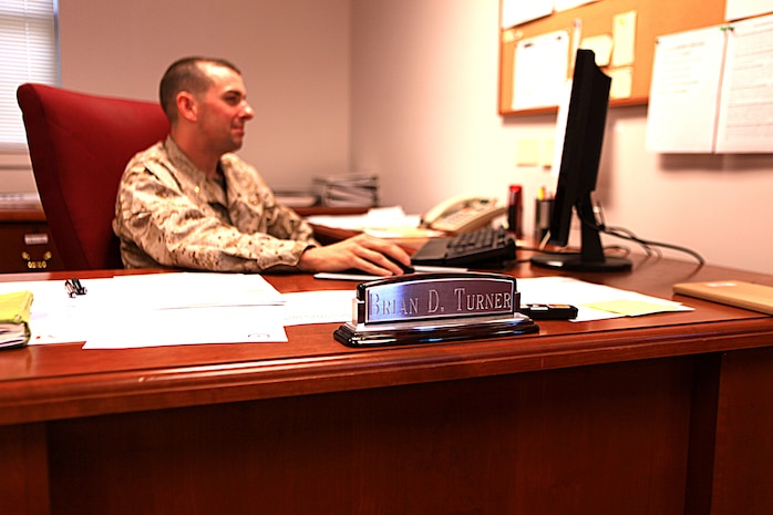 Maj. Brian Turner, the II Marine Expeditionary Force disbursing officer, reads financial documents in his office aboard Camp Lejeune, N.C., May 15, 2012, following an award interview.  Turner has been chosen to receive the Assistant Secretary of the Navy Financial Management and Comptroller Budgeting Award due to the diligent efforts of his disbursing team during their deployment to Helmand province, Afghanistan, 2011-2012.  (U.S. Marine Corps photo by Cpl. Katherine M. Solano)