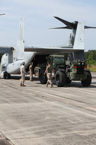 Marines with Air Delivery Platoon, 2nd Marine Logistics Group load a Container Delivery System bundle on to a MV-22 Osprey during a training exercise aboard Camp Lejeune, N.C., May 16, 2012. The Marines teamed up with Marine Medium Tiltrotor Squadron 162, 2nd Marine Aircraft Wing in order to conduct the training, where they dropped eight CDS bundles.