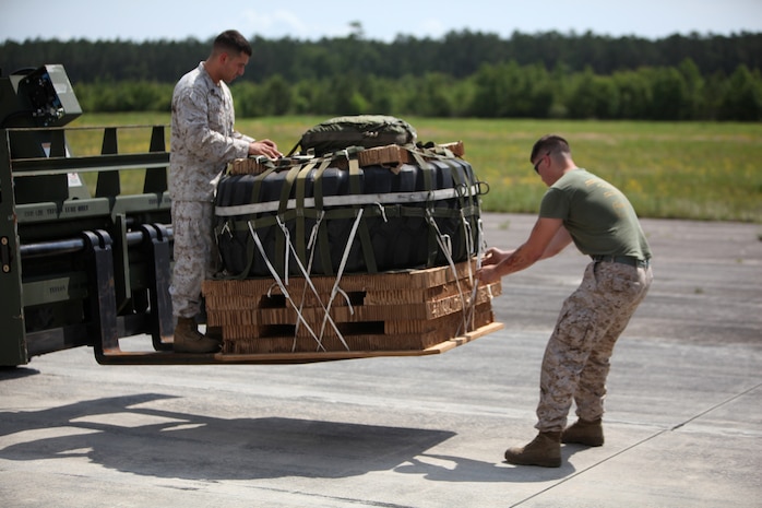 Cpl. Edwin B. Lathrop (left) and Lance Cpl. Austin A. Trowbridge (right), two airborne and air delivery specialist both with 2nd Marine Logistics Group, inspect a Container Delivery System bundle during a training exercise aboard Camp Lejeune, N.C., May 16, 2012.  The air delivery Marines teamed up with Marine Medium Tiltrotor Squadron 162, 2nd Marine Aircraft Wing in order to conduct the training, where they dropped eight CDS bundles.