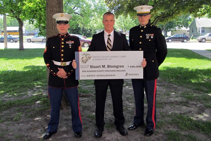 Sgt. Jared Johnson, 26, from St. Cloud, Minn., and Capt. Timothy R. O'Neil, executive officer for Recruiting Station Twin Cities, present Stuart Blomgren from Butterfield-Odin Public School with a Naval Reserve Officers Training Corps Scholarship May 16. Blomgren was one of 17 students in his graduating class. Overall, RS Twin Cities will present eight NROTC Scholarships to students in their area of operations.