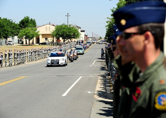 Members of Team Beale salute the motorcade of U.S. Army Spc. Chase Marta during a dignified transfer at Beale Air Force Base, Calif., May 16, 2012. Marta, a Yuba City native, was killed in combat May 7 by an IED while serving in Afghanistan. More than 1,000 Airmen lined the motorcade route to pay their respects with a salute as the procession exited the base. (U.S. Air Force photo by John Schwab/Released)