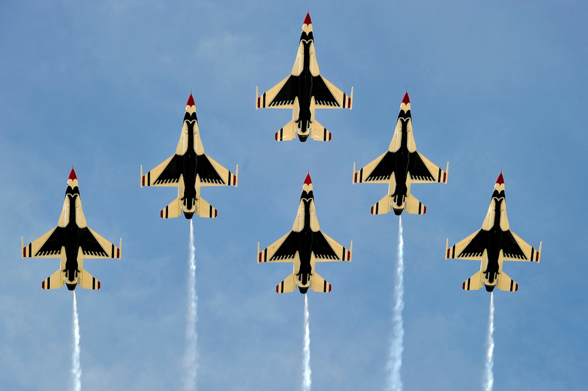 The U.S. Air Force Thunderbirds soar over the airfield in their trademark Delta formation, During their performance May 12. The myriad static displays and aerial displays reflected the now-joint base missions, representing each of the Department of Defense's branches of service as well as numerous civilian aircraft. (U.S. Air Force photo by Tech. Sgt. Parker Gyokeres/Released)