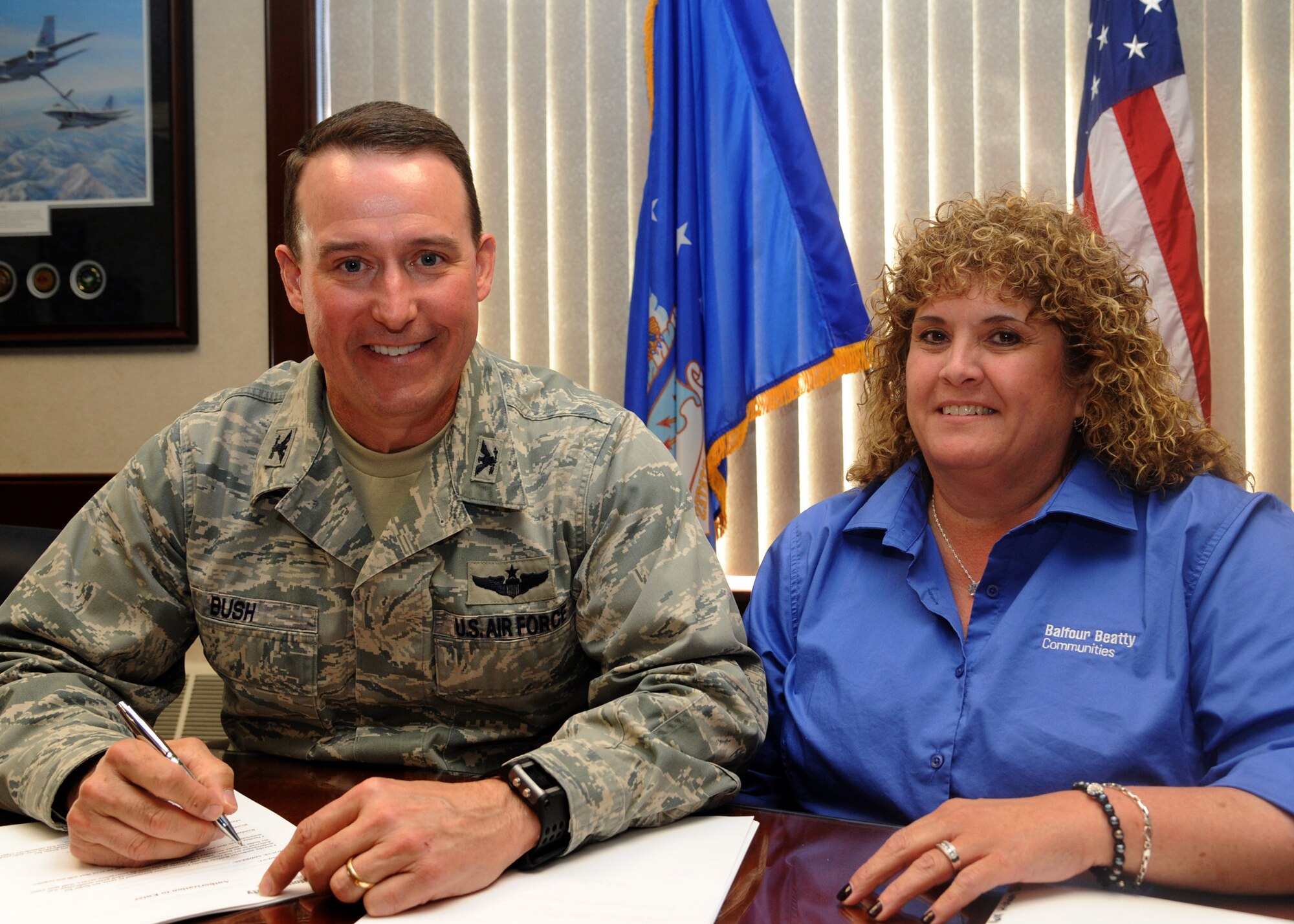 Col. Tim Bush, commander of the 319th Air Base Wing on Grand Forks Air Force Base, N.D., signs his privatized housing lease with Susan Michael, community manager for Balfour Beatty Communities, on May 16, 2012. (U.S. Air Force photo/Senior Airman Amber Bennett)