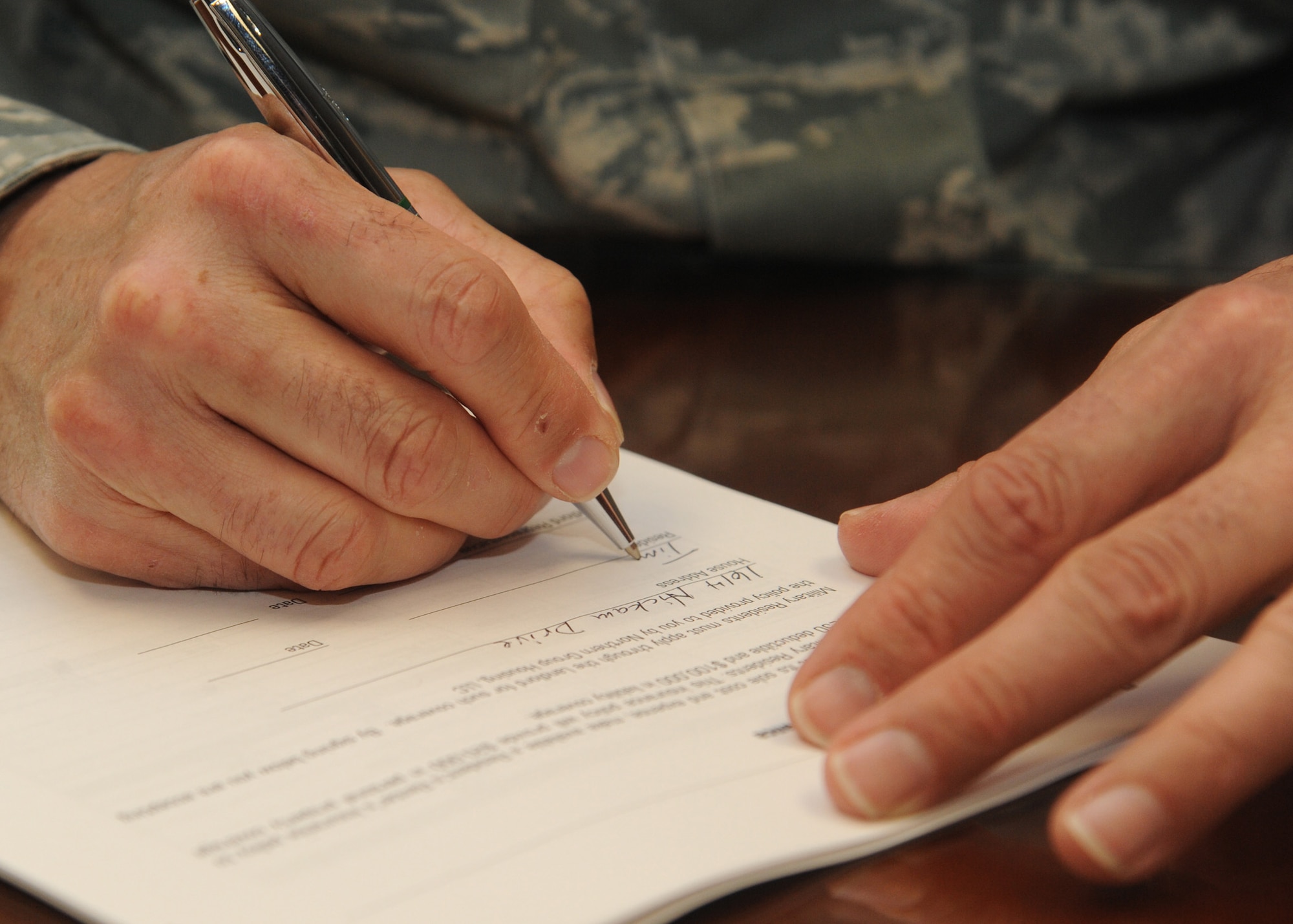 Col. Tim Bush, commander of the 319th Air Base Wing on Grand Forks Air Force Base, N.D., signs his privatized housing lease on May 16, 2012. (U.S. Air Force photo/Senior Airman Amber Bennett)