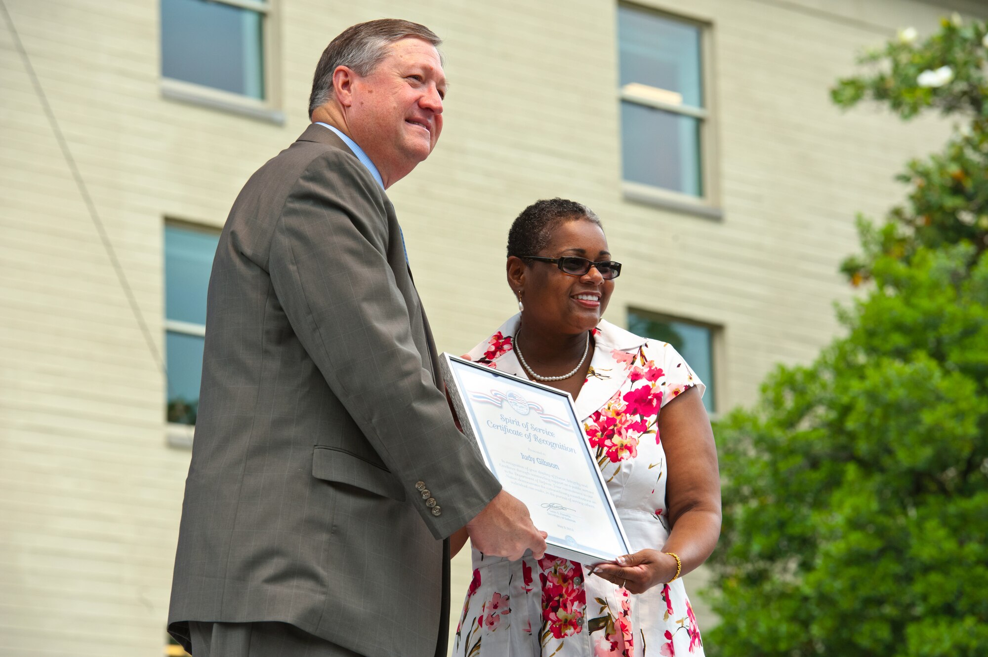 Air Force District of Washington’s Judy Gibson, plans and requirements, accepts a certificate from the Secretary of the Air Force Michael B. Donley for the Department of Defense Spirit of Service Recognition Award to acknowledge her outstanding service during an awards ceremony at the Pentagon, May 9. The award honors DOD civilian employees from the National Capital Region who display core qualities of Honor, Integrity and Excellence in their everyday support to the Department. (Courtesy Photo)