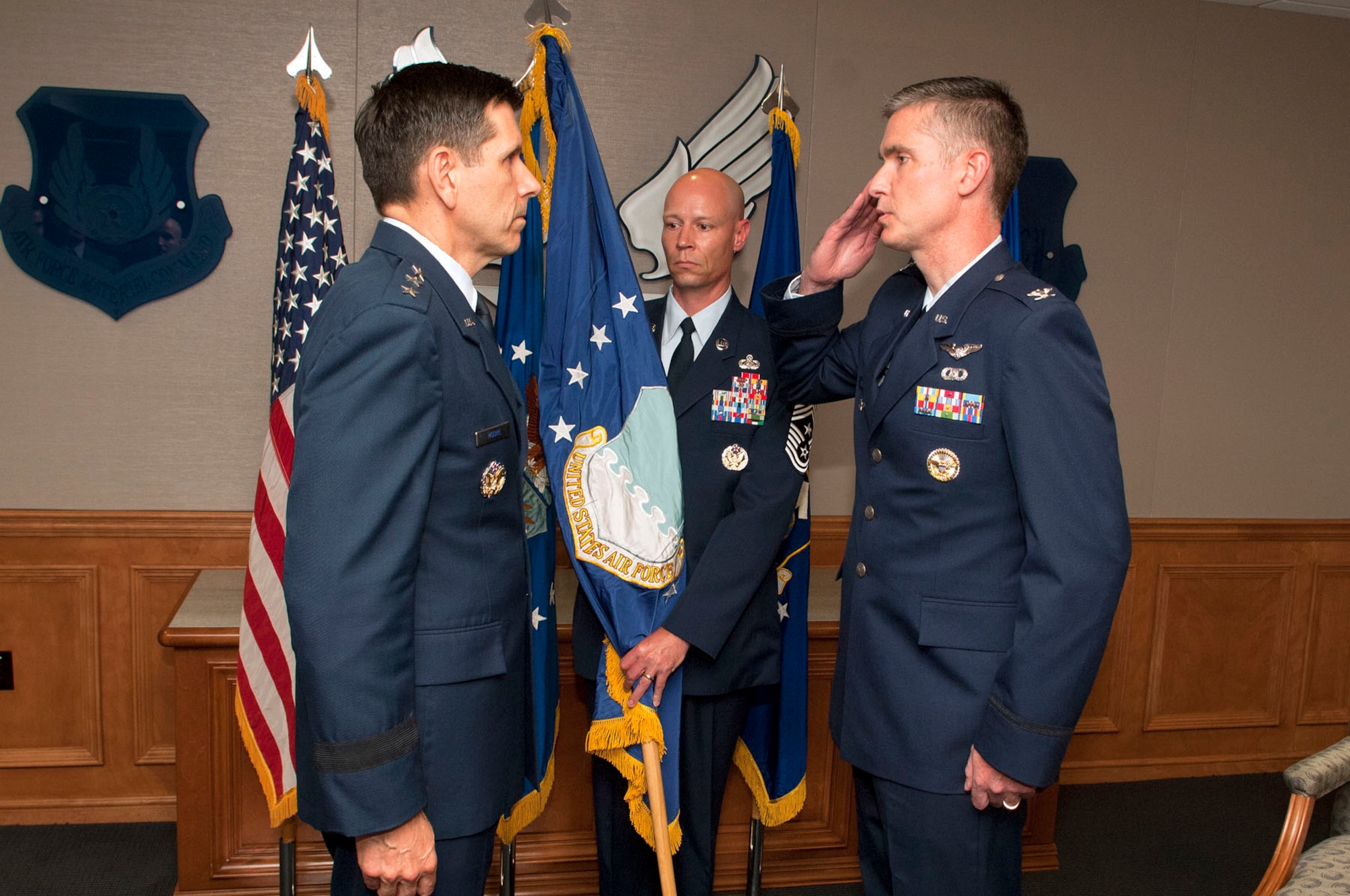 HANSCOM AIR FORCE BASE, Mass. – Col. Mark S. Spillman, new Electronic Systems Center commander, salutes Lt. Gen. C.D. Moore II, Air Force Materiel Command vice commander, as Chief Master Sgt. Kevin Call, ESC command chief, holds the flag during an appointment of command ceremony May 15. Spillman’s appointment was necessitated by an earlier-than-expected departure of former ESC Commander Lt. Gen. CR Davis. (U.S. Air Force photo by Mark Wyatt)