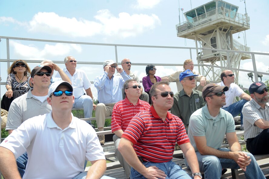 Members of the National Defense Industry Association, Georgia Chapter, watch as an A-10 C Thunderbolt II fires toward ground targets at the Grand Bay Bombing and Gunnery Range at Moody Air Force Base, Ga., May 15, 2012. The demonstration showcased the A-10’s abilities to conduct close air support. (U.S. Air Force photo by Airman 1st Class Douglas Ellis/Released)
