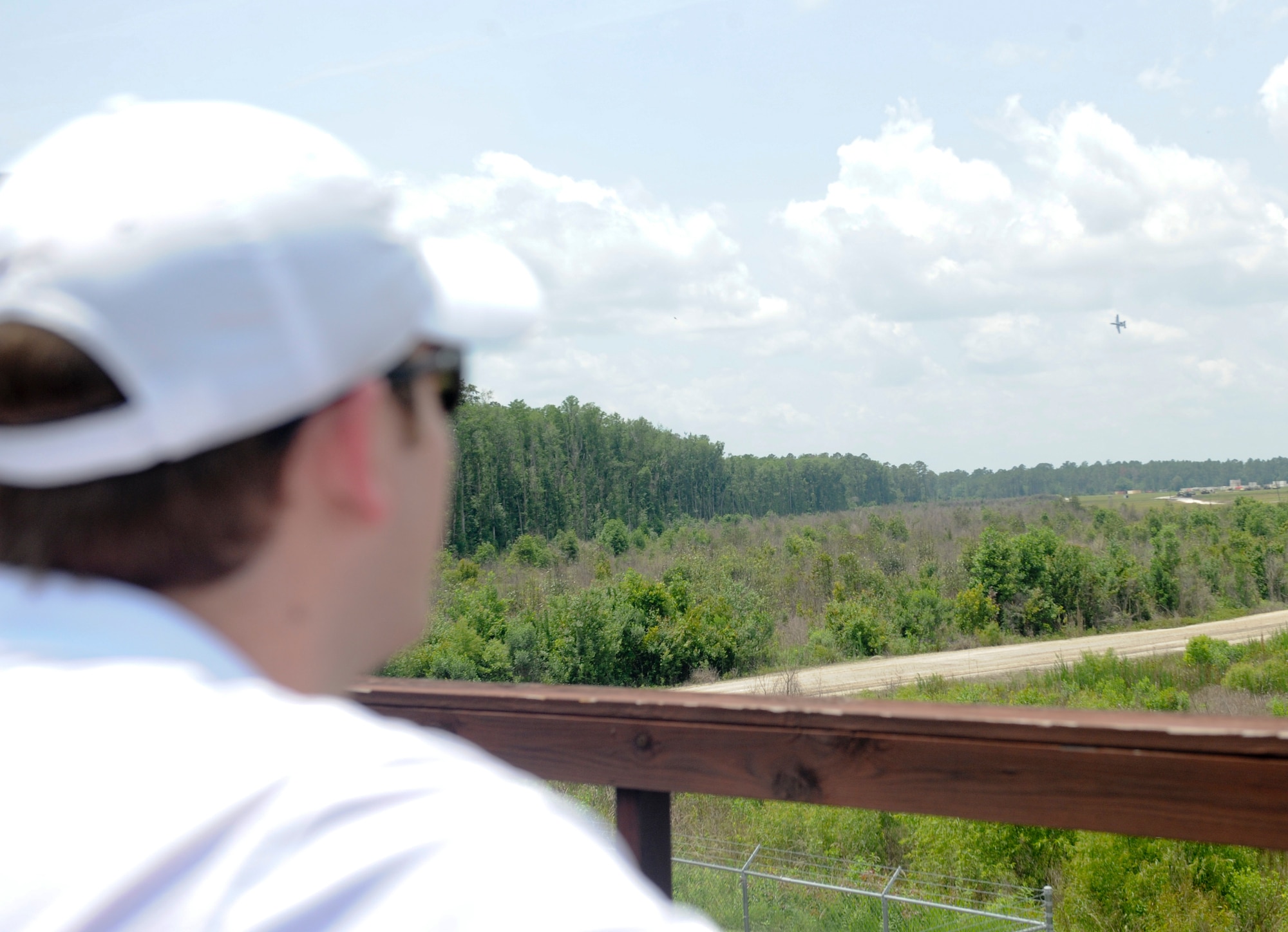 A member of the National Defense Industry Association, Georgia Chapter, watches an A-10 C Thunderbolt II at the Grand Bay Bombing and Gunnery Range while visiting Moody Air Force Base, Ga., May 15, 2012. The NDIA Georgia chapter visited Moody to better understand the mission and capabilities of Moody. (U.S. Air Force photo by Airman 1st Class Douglas Ellis/Released)
