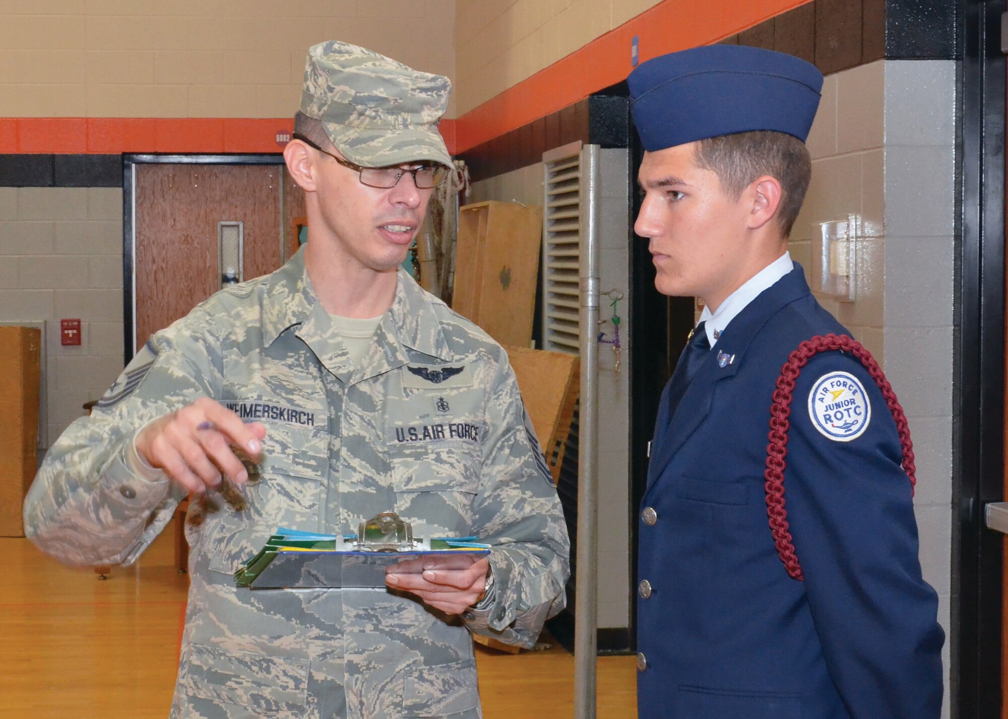 WRIGHT-PATTERSON AIR FORCE BASE, Ohio - Master Sgt. Geof Weimerskirch, 445th  Aeromedical Evacuation Squadron, briefs  a cadet from  the Lebannon Air Force JROTC Drill Team, prior to their performance April 14 at the Delaware County Drill Meet. (U.S. Air Force photo/Senior Airman Matthew Cook)