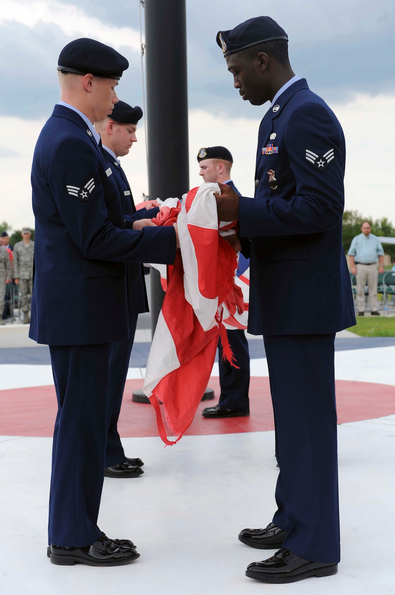 U.S. Air Force Airmen from the 23d Security Forces Squadron fold the flag during a Police Week retreat ceremony at President George W. Bush Air Park, Moody Air Force Base, Ga., May 15, 2012. This ceremony marked the 50th anniversary of National Police Week. (U.S. Air Force photo by Staff Sgt. Ciara Wymbs/Released)