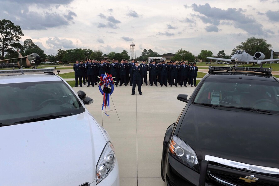 U.S. Air Force Airmen assigned to the 23d Security Forces Squadron stand in formation honoring Police Week at President George W. Bush Air Park, Moody Air Force Base, Ga., May 15, 2012. Each year between 140 and 160 officers are killed in the line of duty. (U.S. Air Force photo by Staff Sgt. Ciara Wymbs/Released)