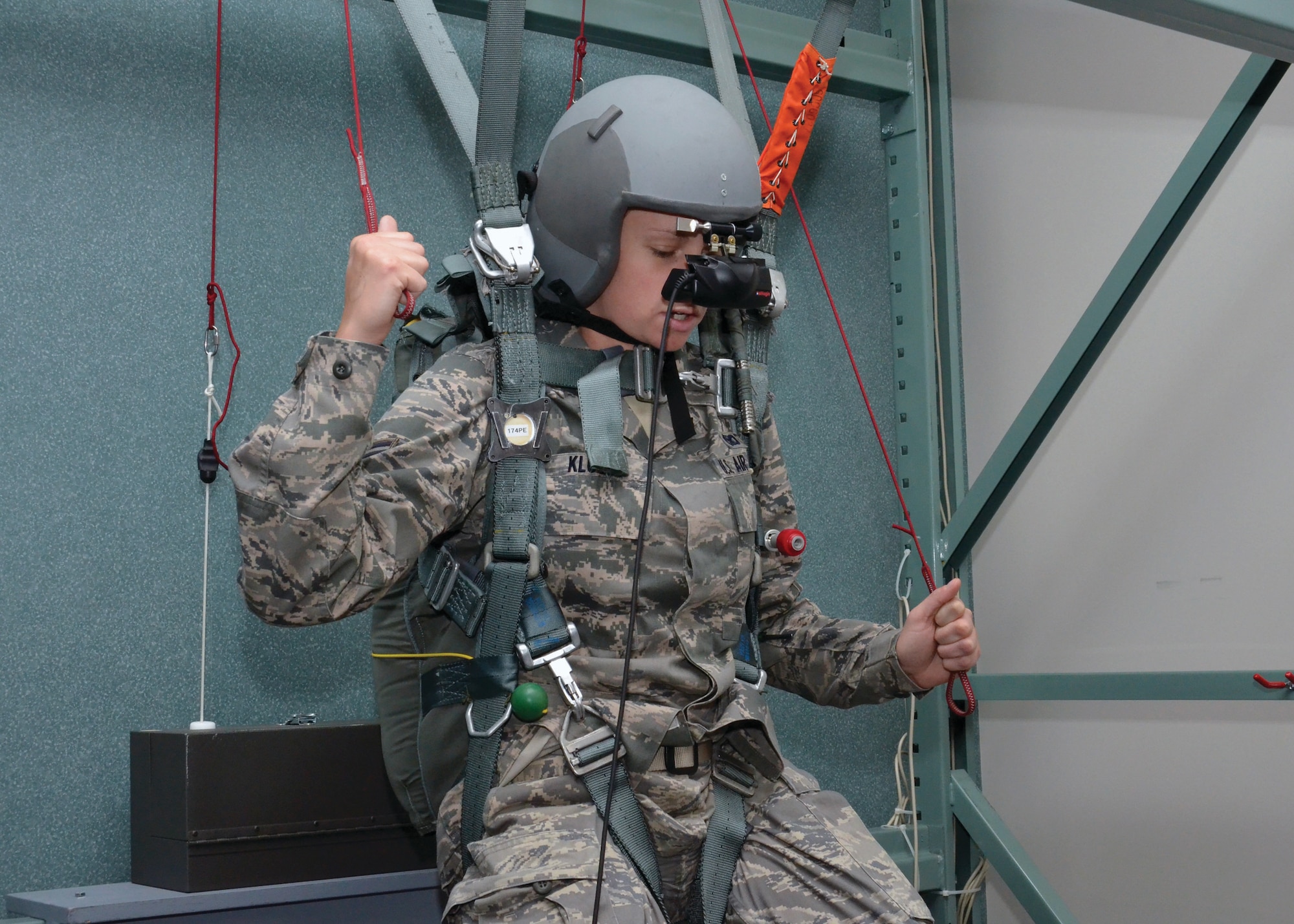 WRIGHT-PATTERSON AIR FORCE BASE, Ohio - Senior Airman Alexandra Klus, 445th Security Forces Squadron, tries to "safely land" during a scenario run on the parachute simulator during the wing Airman's Council tour of the 445th Operations Support Squadron April 15. (U.S. Air Force photo/Senior Airman Matthew Cook)