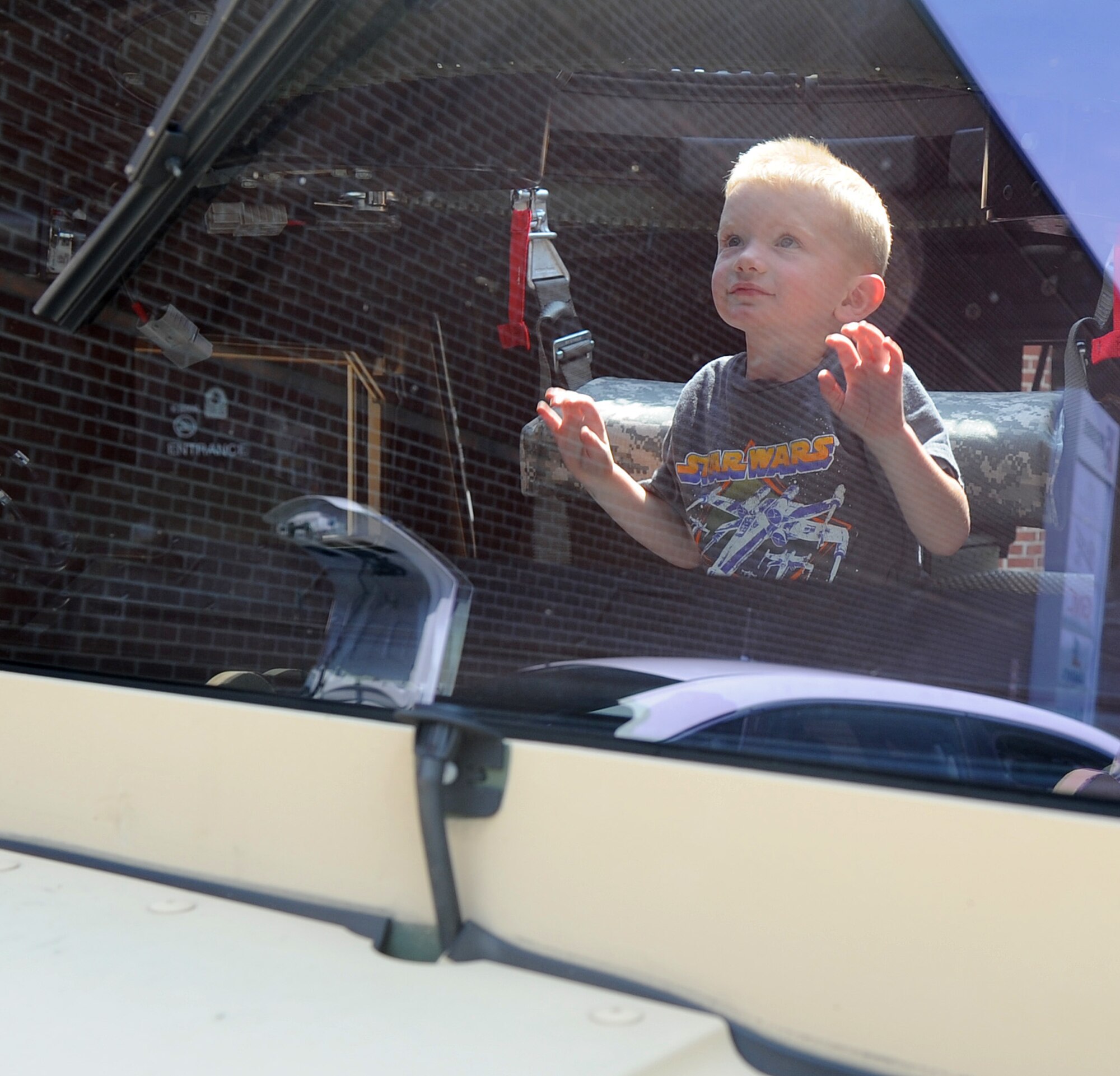 Hayden Wyble sits inside a Humvee during a 4th Security Forces Squadron weapons, gear and vehicle display on Seymour Johnson Air Force Base, N.C., May 16, 2012. The display in front of the base commissary and exchange allowed shoppers to stop by and learn about life as a SFS Airman. Hayden is the son of U.S. Air Force Master Sgt. Benoit Wyble who is a member of the 4th SFS. (U.S. Air Force photo/Senior Airman Gino Reyes/Released)