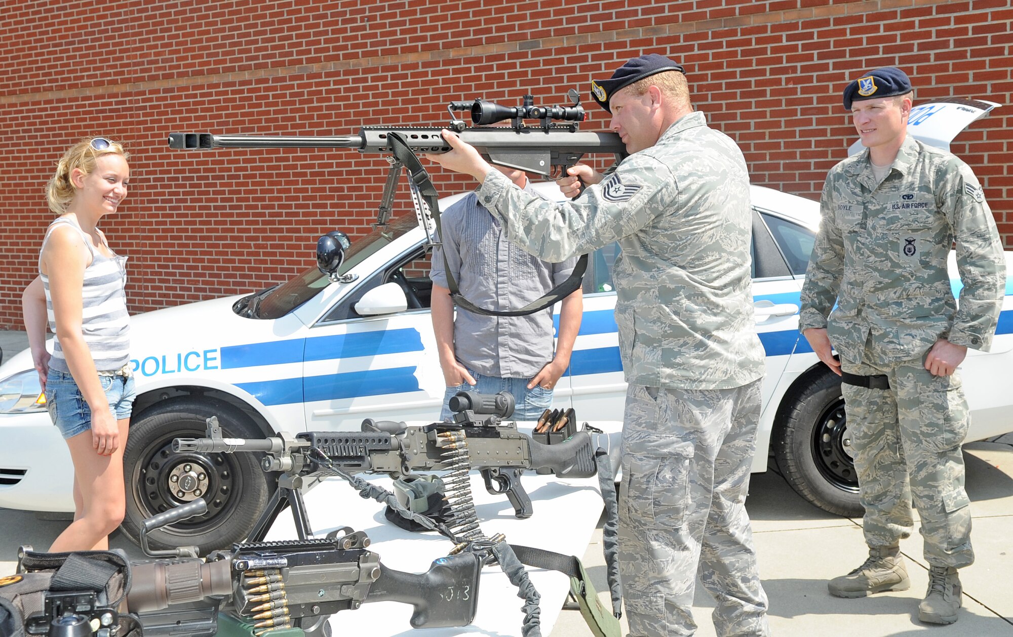 U.S. Air Force Tech. Sgt. Matthew Lack demonstrates how to properly hold an M107 Barrett sniper rifle at a 4th Security Forces Squadron weapons, gear and vehicle display on Seymour Johnson Air Force Base, N.C., May 16, 2012. The display was designed to show people what tools the 4th SFS Airmen use while performing various duties at homestation and deployed locations. Lack, 4th SFS NCO in charge of mobility, hails from Modesto, Calif. (U.S. Air Force photo/Senior Airman Gino Reyes/Released)