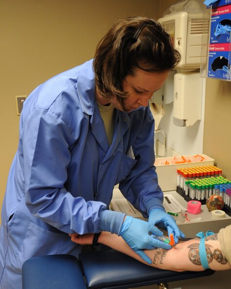 Staff. Sgt. Charlee Martin, 2nd Medical Group laboratory technician, inserts a needle into a patient to draw blood on Barksdale Air Force Base, La., May 16. The 2 MDG offers Team Barksdale members a variety of specialty clinics and services such allergy and immunizations, chiropractor, dentistry, family health, pharmacy and physical therapy. (U.S. Air Force photo/Senior Airman Sean Martin)(RELEASED)