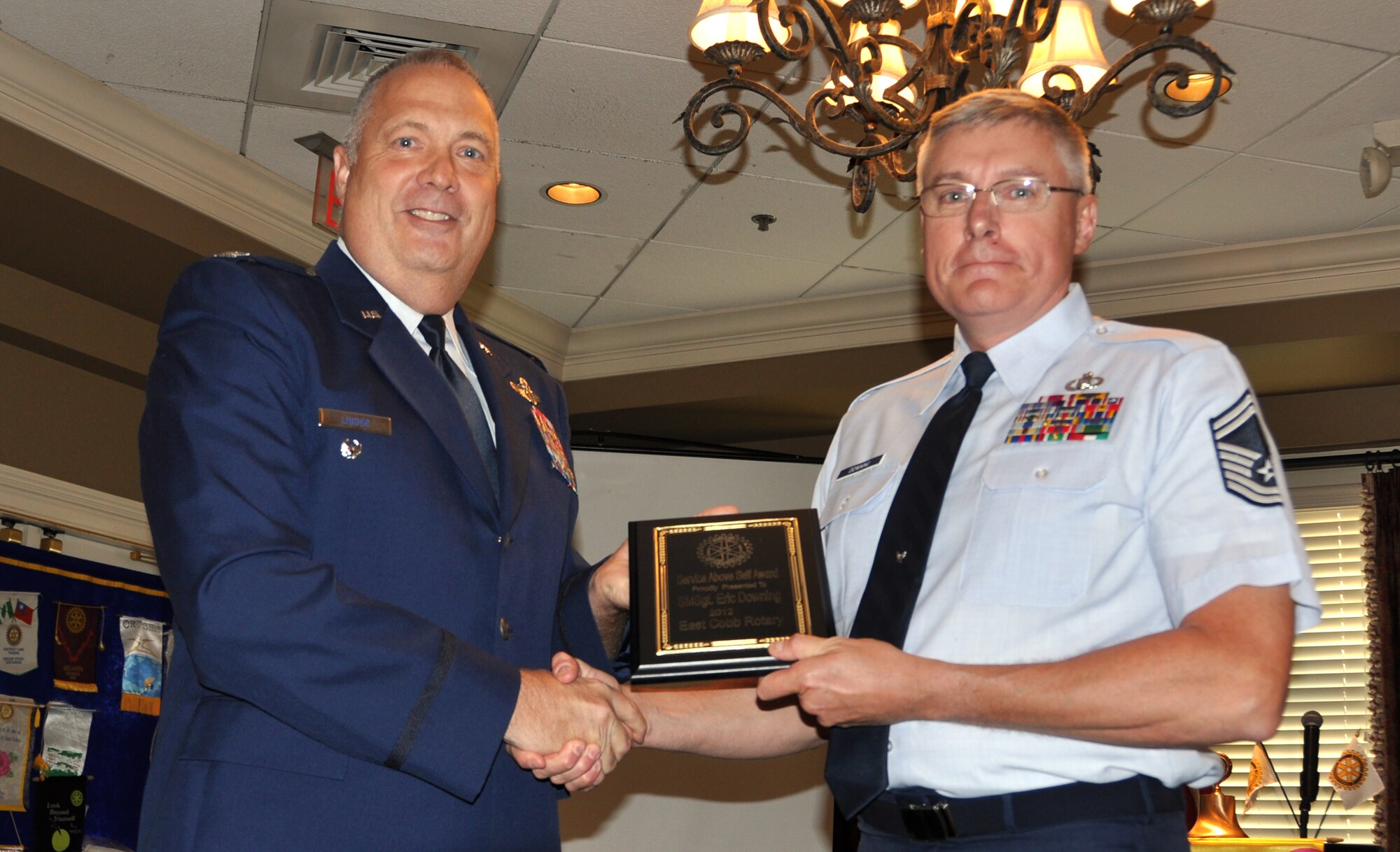 Col. James Linder, of the 22nd Air Force, presents Senior Master Sgt. Eric Downing with the East Cobb Rotary Club’s Military Service Above Self Award on May 16 at Indian Creek Country Club in Marietta, Ga. (U.S. Air Force photo/Airman 1st Class Elizabeth Gaston)