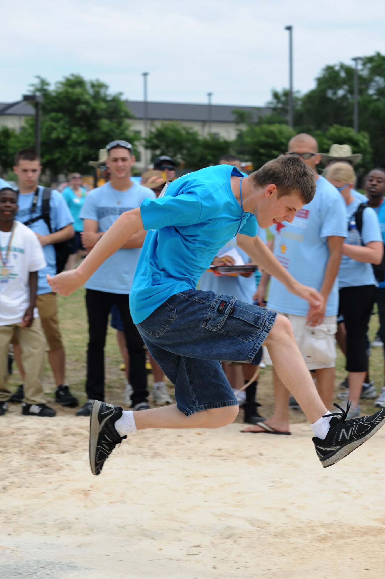 Collin Sartin, athlete, leaps into the air during his turn in the running long jump competition during the Special Olympics Mississippi Summer Games, May 12, 2012, at Keesler Air Force Base, Miss. It’s the 26th year that Keesler has hosted the statewide event. Opening ceremonies took place May 11. Athletic competitions took place throughout the day and were followed by a victory dance May 12. More than 1,200 athletes and coaches and 3,000 volunteers joined forces to make the event a success.  (U.S. Air Force photo by Kemberly Groue)