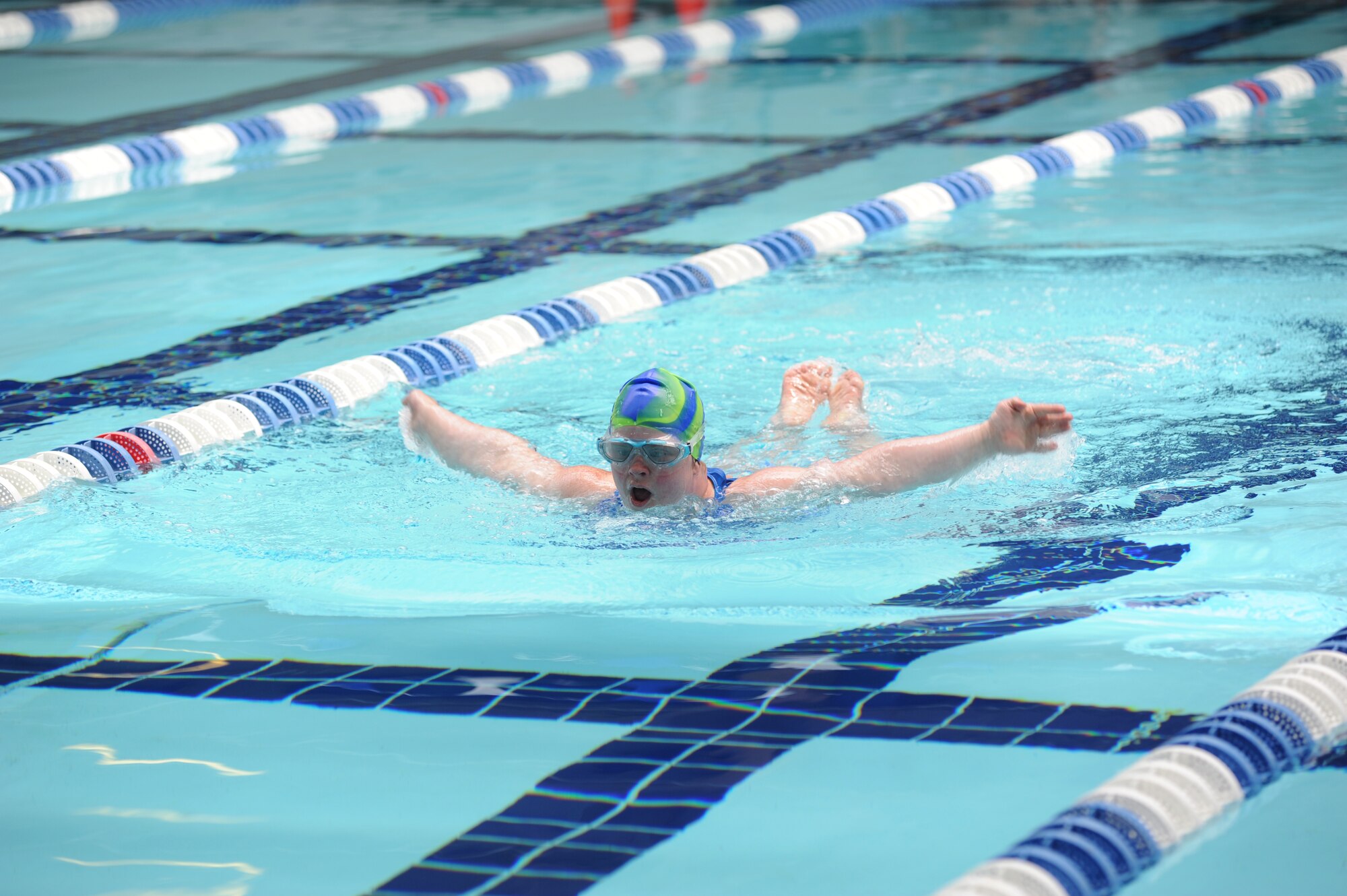 Tabitha Turnage, athlete, does the butterfly stroke in the 100 yard individual medley swim competition at the Biloxi Natatorium, Biloxi, Miss., during the Special Olympics Mississippi Summer Games, May 12, 2012.  It’s the 26th year that Keesler Air Force Base, Miss., has hosted the statewide event. Opening ceremonies took place May 11. Athletic competitions took place throughout the day and were followed by a victory dance May 12. More than 1,200 athletes and coaches and 3,000 volunteers joined forces to make the event a success.  (U.S. Air Force photo by Kemberly Groue)
