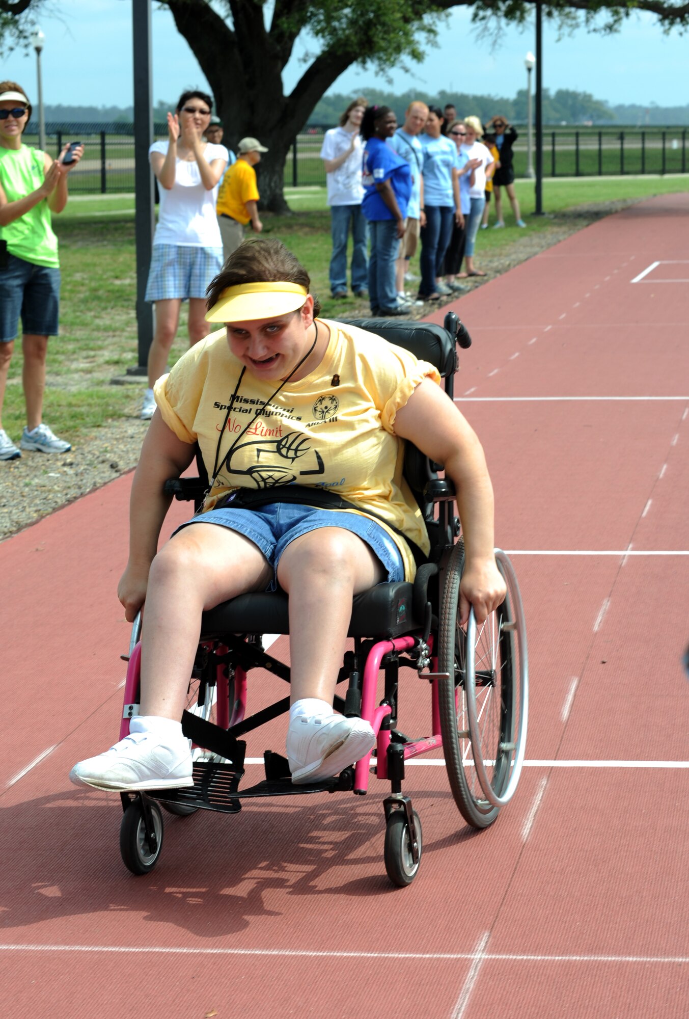 Tiffany Henegar, athlete, wheels herself down the track in the 25 meter wheelchair race during the Special Olympics Mississippi Summer Games, May 12, 2012, at Keesler Air Force Base, Miss. It’s the 26th year that Keesler has hosted the statewide event. Opening ceremonies took place May 11. Athletic competitions took place throughout the day and were followed by a victory dance May 12. More than 1,200 athletes and coaches and 3,000 volunteers joined forces to make the event a success.  (U.S. Air Force photo by Kemberly Groue)