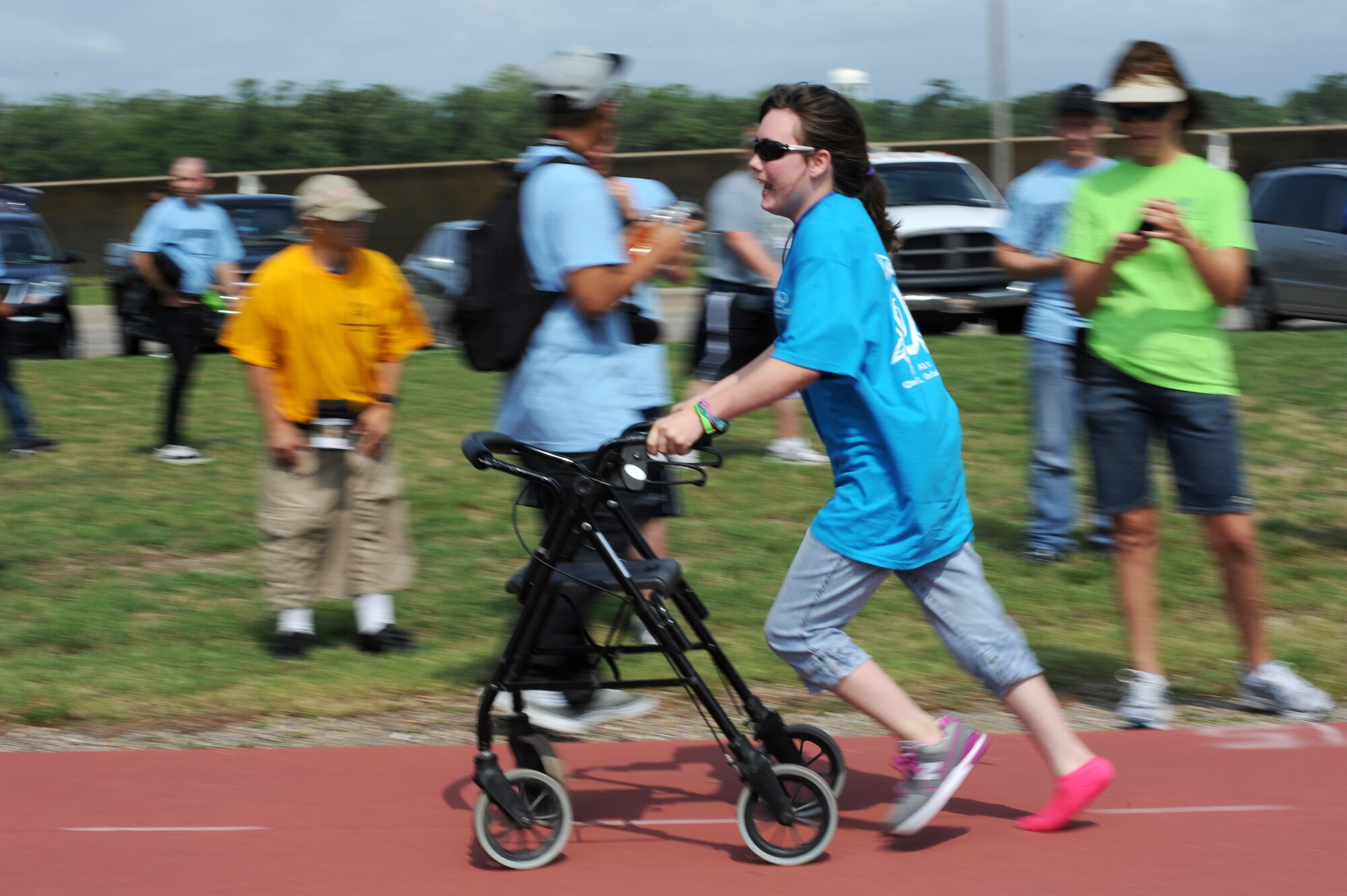 Fifteen-year-old, Shelby Smith, athlete, participates in the 25 meter assisted walk during the Special Olympics Mississippi Summer Games, May 12, 2012, at Keesler Air Force Base, Miss. It’s the 26th year that Keesler has hosted the statewide event. Opening ceremonies took place May 11. Athletic competitions took place throughout the day and were followed by a victory dance May 12. More than 1,200 athletes and coaches and 3,000 volunteers joined forces to make the event a success.  (U.S. Air Force photo by Kemberly Groue)