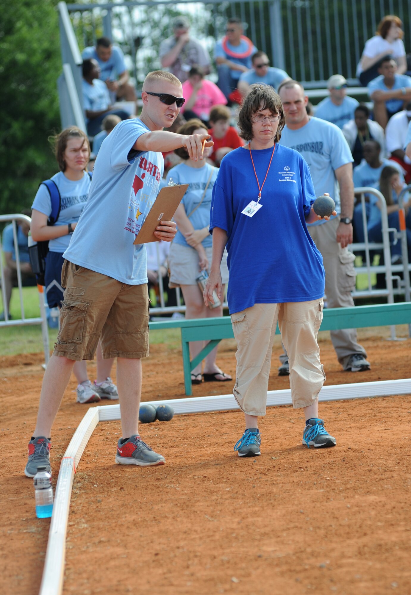 Volunteer Lance Cpl. Andrew Hopperstad, Keesler Marine Detachment, assists Peggy Settlemire, athlete, in a game of Bocce during the Special Olympics Mississippi Summer Games, May 12, 2012, at Keesler Air Force Base, Miss. It’s the 26th year that Keesler has hosted the statewide event. Opening ceremonies took place May 11. Athletic competitions took place throughout the day and were followed by a victory dance May 12. More than 1,200 athletes and coaches and 3,000 volunteers joined forces to make the event a success.  (U.S. Air Force photo by Kemberly Groue)