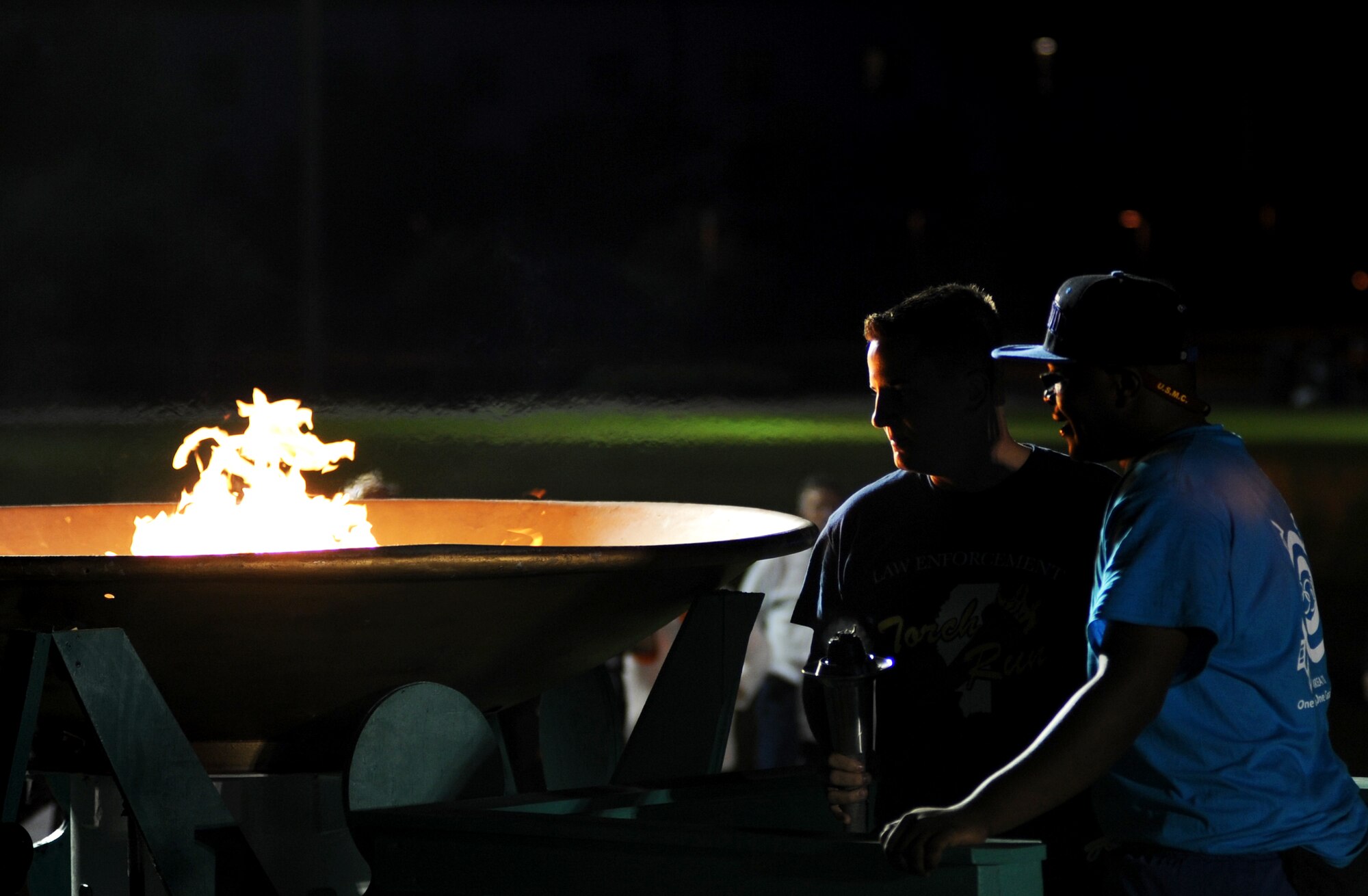 Senior Airman Cody Chandler, 81st Security Forces Squadron, who was hand selected by 81 SFS leadership, and Jasper McKnight, athlete, light the caldron during the opening ceremonies of the Special Olympics Mississippi Summer Games, May 11, 2012, at Keesler Air Force Base, Miss. It’s the 26th year that Keesler has hosted the statewide event.  Athletic competitions took place throughout the day and were followed by a victory dance May 12. More than 1,200 athletes and coaches and 3,000 volunteers joined forces to make the event a success.  (U.S. Air Force photo by Kemberly Groue)