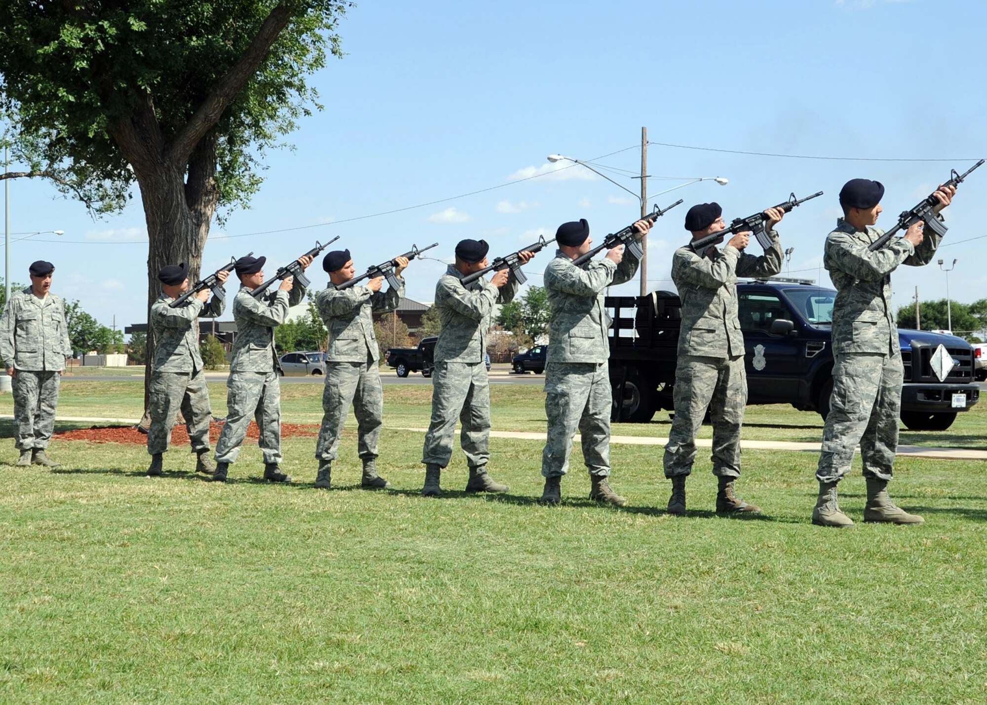 ALTUS AIR FORCE BASE, Okla. – Airmen from the 97th Security Forces Squadron fire M4 carbines during reveille in honor of Police Week and National Peace Officers Day at the Wings of Freedom Park, May 15, 2012. In 1962, President John F. Kennedy Jr. designated this day to be National Peace Officers Day to honor officers who gave their lives in the line of duty. (U.S. Air Force photo by Airman 1st Class Franklin R. Ramos / 97th Air Mobility Wing / Released)