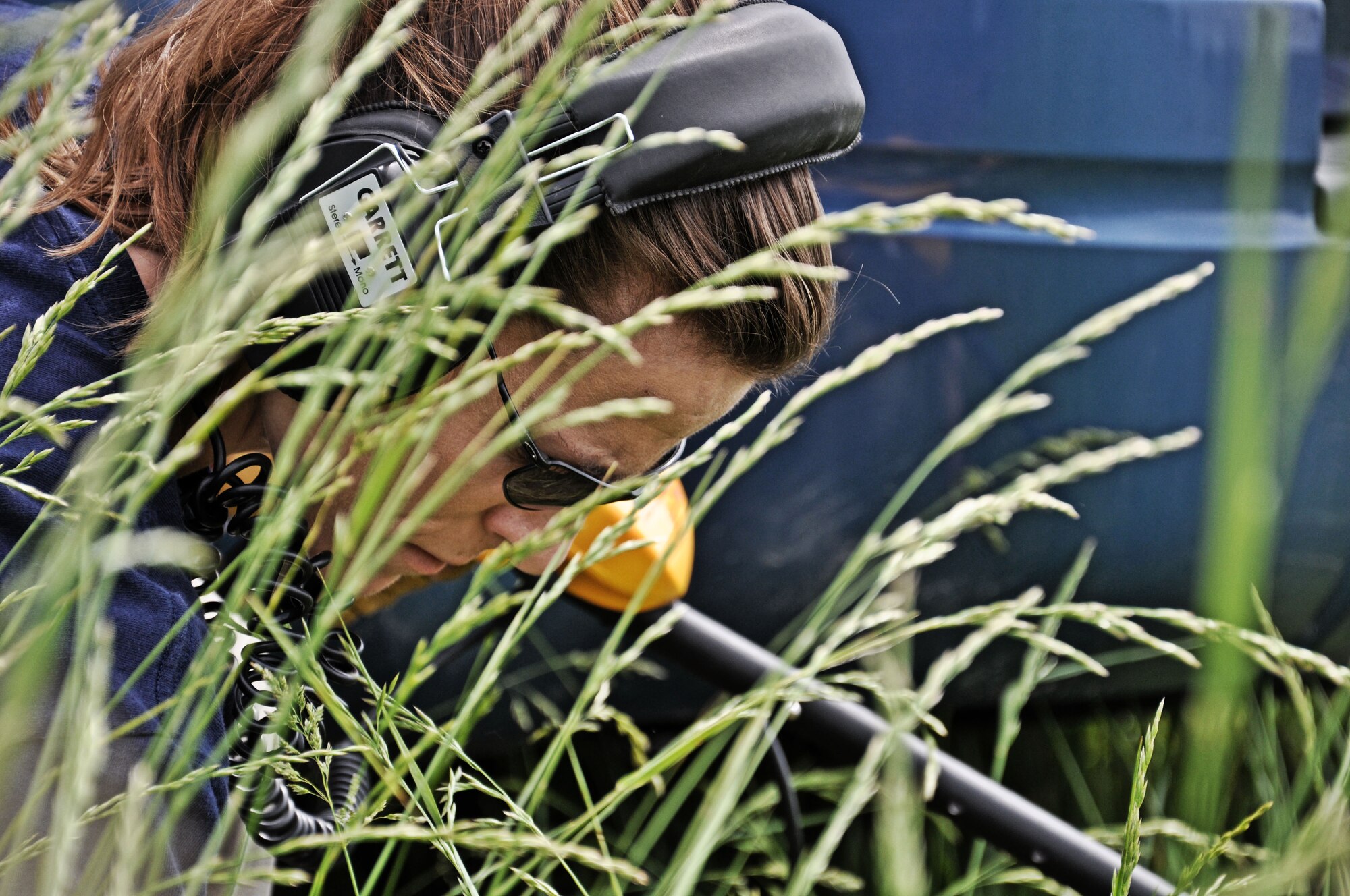 Special Agent Brooke Gaynor, Federal Bureau of Investigation St. Louis division, searches the grass where she suspects a piece of evidence to be found at the Mascoutah gate May 8, 2012, at Scott Air Force Base, Ill. Participants of the training had to document the scene, investigate why it happened and find out where the injured criminal had fled to through photographs, evidence, blood testing technology and a variety of other techniques and technology. (U.S. Air Force photo/Airman 1st Class Jake Eckhardt)