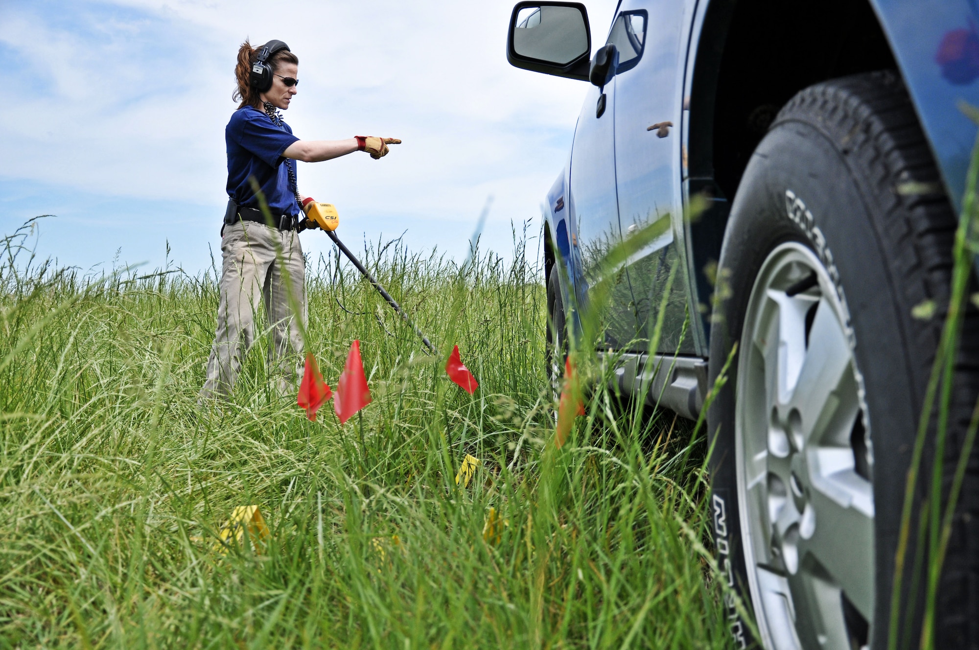 Special Agent Brooke Gaynor, Federal Bureau of Investigation St. Louis division, uses a metal detector to locate evidence for a training scenario at the Mascoutah gate May 8, 2012, at Scott Air Force Base, Ill. The FBI St. Louis and Springfield Evidence Response Teams have trained at Scott AFB twice this year to improve the FBI’s coordination with the United States military. (U.S. Air Force photo/Airman 1st Class Jake Eckhardt)