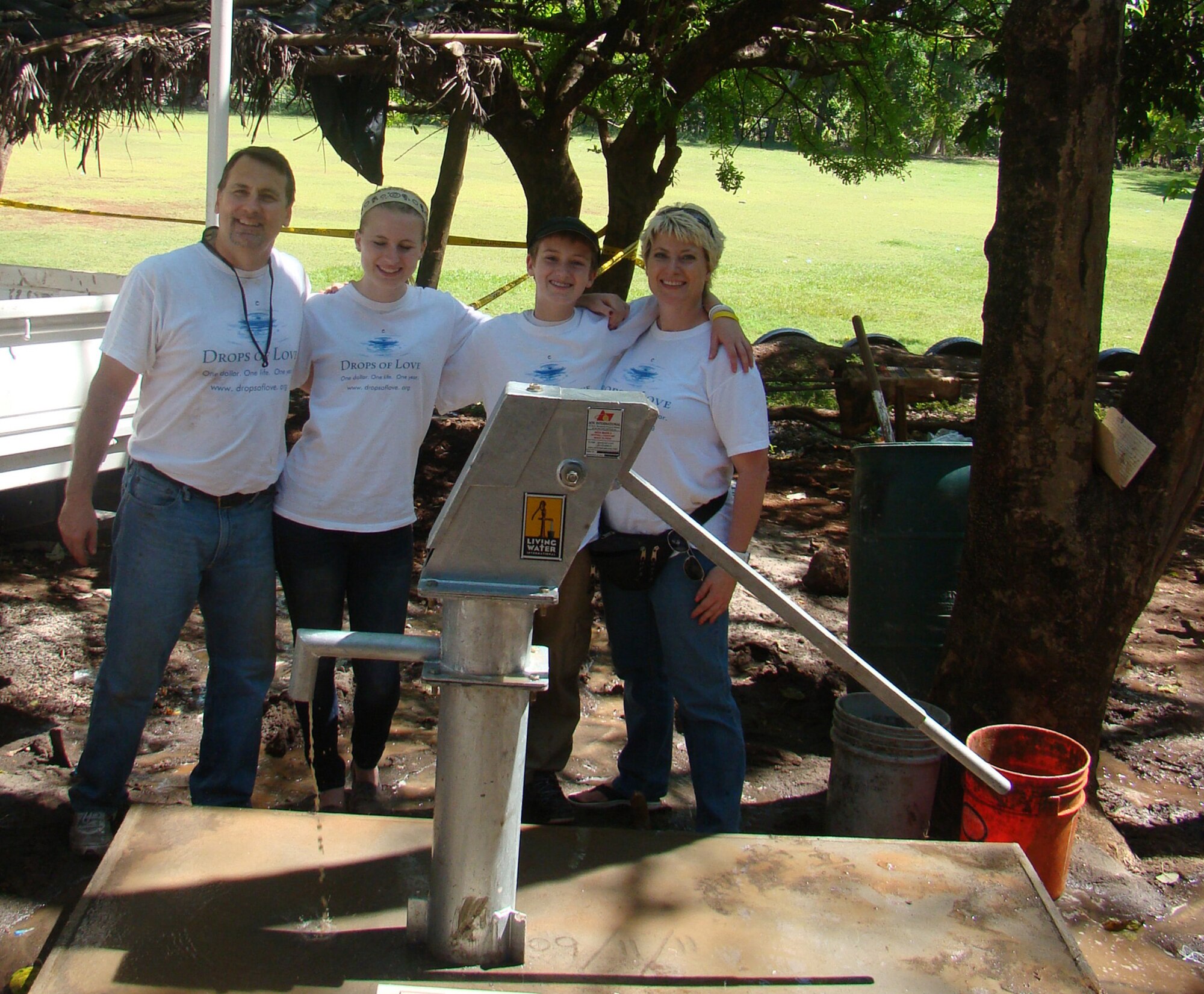 Members of "Drops of Love", a non-profit organization with the mission of drilling water wells in impoverished countries in Africa and Central America, take a break from drilling a well in El Salvador. Lt. Col. Kelli Smiley (right), 446th Force Support Squadron commander out of McChord Field, Wash. serves on the company's board of directors under daughter Mariah's (second from left) "command." The entire Smiley family is involved in the organization. (Courtesy photo) 