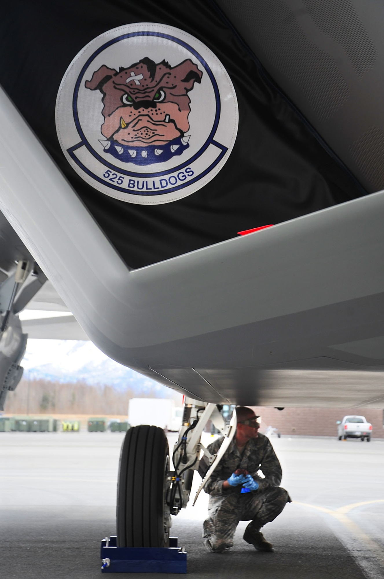 Airman 1st Class Jeffery Brown performs post flight checks after an F-22 Raptor fighter landed on the flightline May 5. The 525th Fighter Squadron, Joint Base Elmendorf-Richardson, received the last F-22 Raptor being made from Lockheed Martin and has named it the squadron's flagship. Brown is the jet's assistant dedicated crew chief with the 525th Aircraft Maintenance Unit from Booneville, Miss. (U.S. Air Force photo/Staff Sgt. Cynthia Spalding)