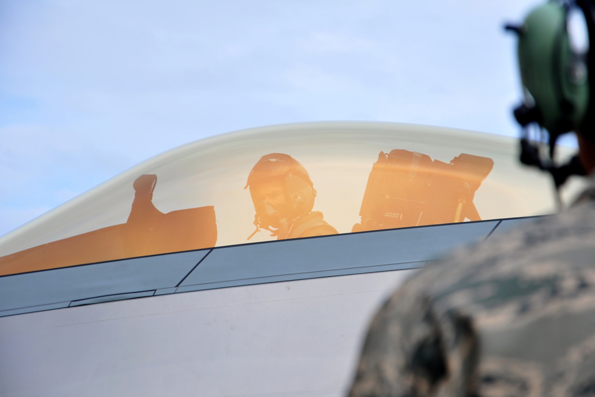 Air Force Lt. Col. Paul Moga, 525th Fighter Squadron Commander, talks with Senior Airman Joshua King after landing on the flightline May 5. The 525th Fighter Squadron, Joint Base Elmendorf-Richardson, received the last F-22 Raptor being made from Lockheed Martin and has named it the squadron's flagship. King is the aircraft's assistant dedicated crew chief with the 525th Aircraft Maintenance Unit from Collinsville, Okla. (U.S. Air Force photo/Staff Sgt. Cynthia Spalding)