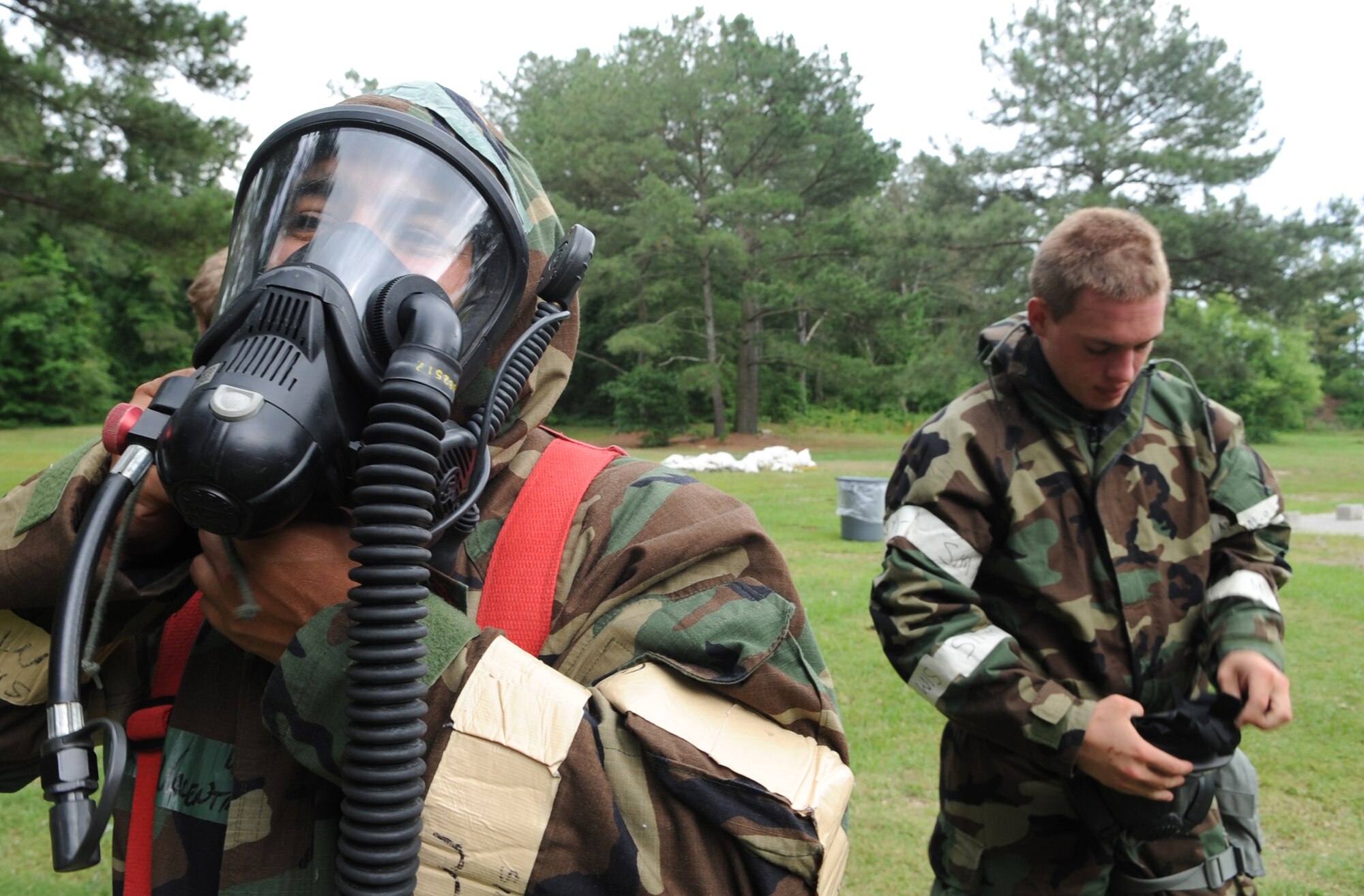 U.S. Air Force Staff Sgt. Skipper Valentin-Cruzado attempts to remove his gas mask during ability to survive and operate training in a chemical, biological, radiological and nuclear environment on Seymour Johnson Air Force Base, N.C., May 15, 2012. Military members must practice proper reactions to fluctuating force protection conditions and mission oriented protective posture levels to prepare for real-world CBRN attacks. Valentin-Cruzado, 4th Civil Engineer Squadron logistics NCO in charge, hails from Mayaguez, Puerto Rico. (U.S. Air Force photo/Airman 1st Class Aubrey Robinson/Released)