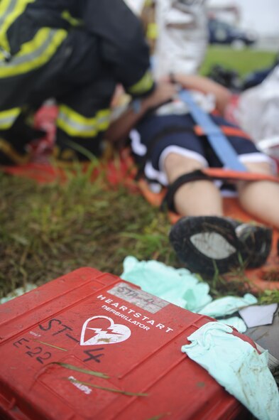 A Kadena firefighter treats a "casualty" during a simulated aircraft fire as part of Beverly High 12-4, a local operational readiness exercise, on Kadena Air Base, Japan, May 16, 2012. Kadena's Airmen use LOREs to test themselves in the ability to survive and operate (ATSO) under various conditions. (U.S. Air Force photo/Airman 1st Class Maeson L. Elleman)
