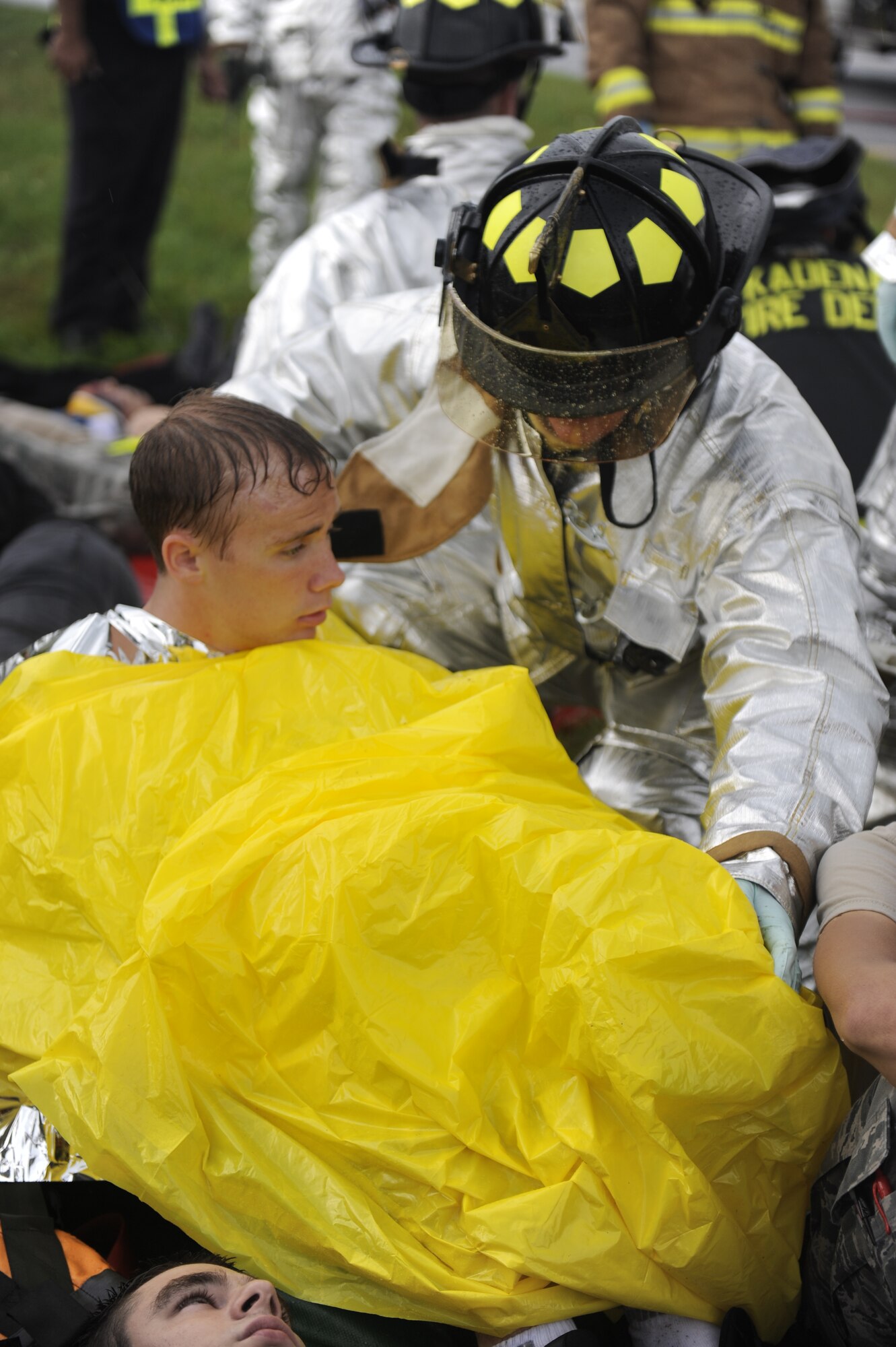 A Kadena firefighter wraps a blanket around a simulated casualty during an emergency management exercise (EME) taking place during local operational readiness exercise Beverly High 12-4 on Kadena Air Base, Japan, May 16, 2012. The LORE is designed to train Kadena's Airmen to survive and operate under various conditions in order to prepare them for future operations and contingencies. (U.S. Air Force photo/Airman 1st Class Maeson L. Elleman)