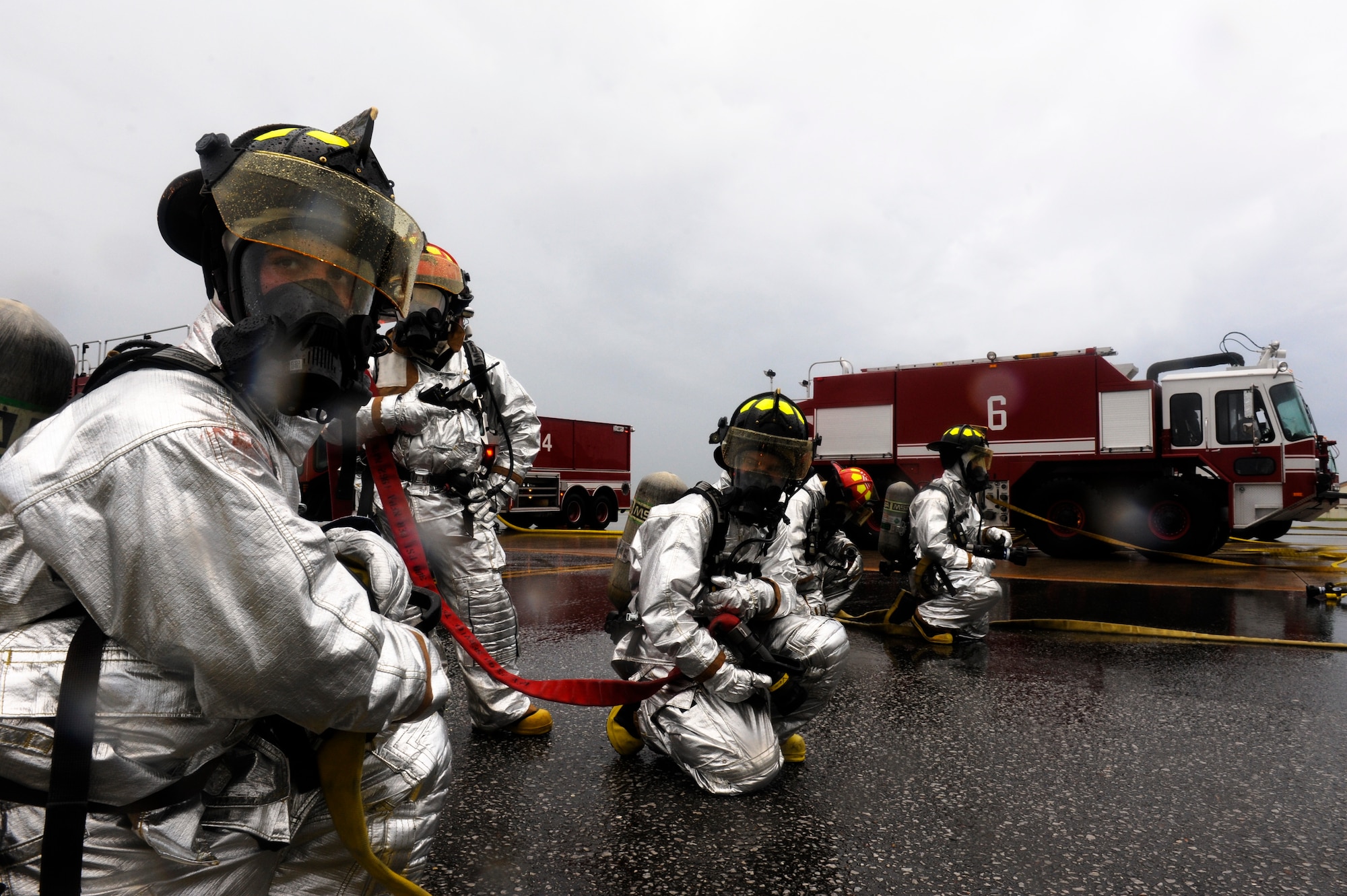 Kadena firefighters posture themselves on the flightline to extinguish a simulated aircraft fire as part of Beverly High 12-4, a local operational readiness exercise on Kadena Air Base, Japan, May 16, 2012. The LORE is designed to train Kadena's Airmen to survive and operate under various conditions ranging from chemical attacks to aircraft crashes. (U.S. Air Force photo/Airman 1st Class Maeson L. Elleman)
