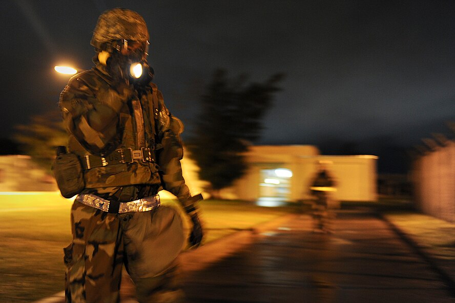 U.S. Air Force Senior Airman Simon Tan, 18th Communication Squadron client systems technician, checks for unidentified explosive ordnance while on a post-attack reconnaissance sweep during local operational readiness exercise Beverly High 12-4 on Kadena Air Base, Japan, May 16, 2012. LOREs are conducted on a regular basis to test the base's ability to defend Japan and maintain peace and stability in the Pacific region. (U.S. Air Force photo/Airman 1st Class Brooke P. Beers)