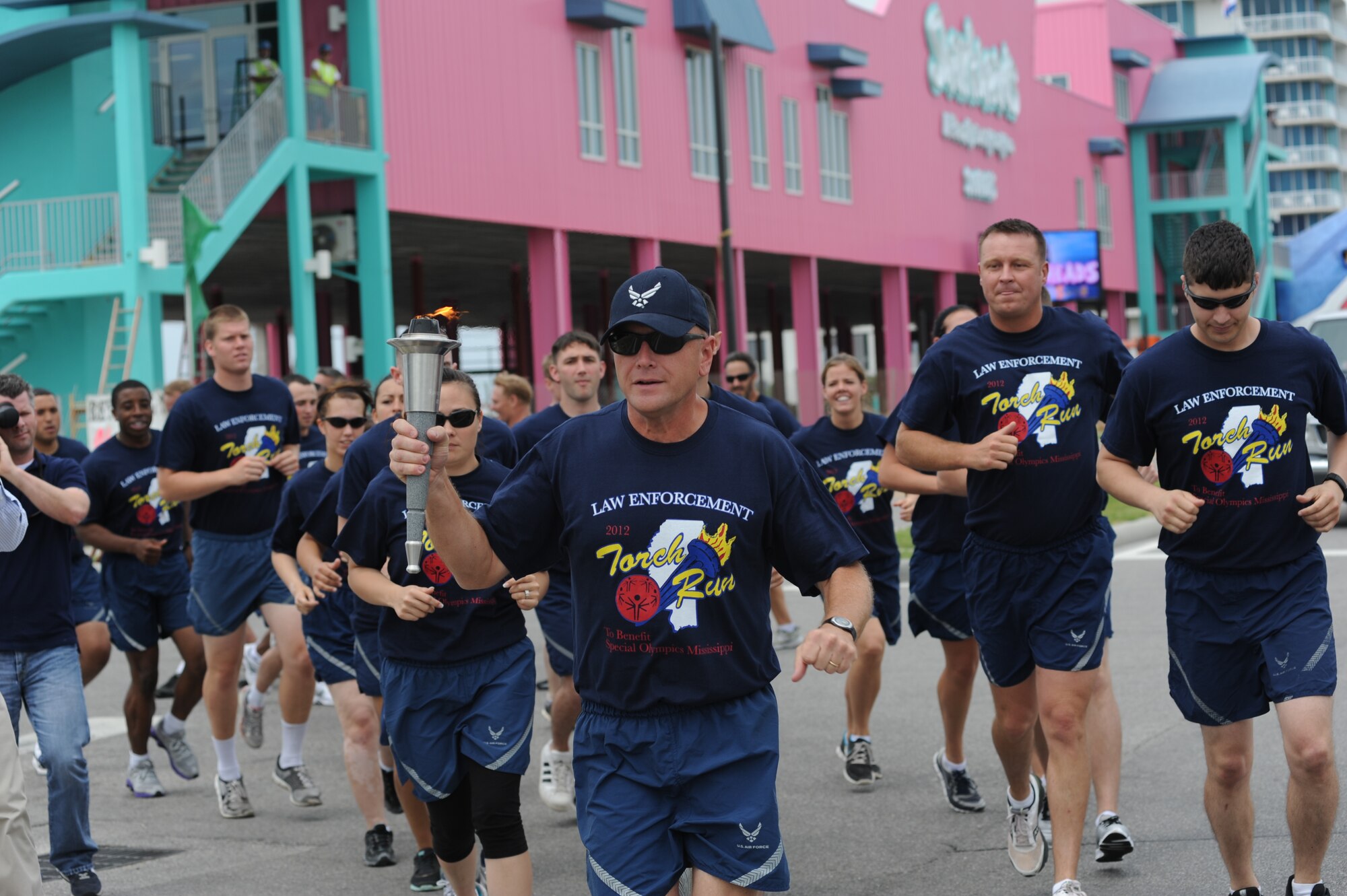 Brig. Gen. Andrew Mueller, 81st Training Wing commander, carries the “Flame of Hope” down Highway 90 accompanied by runners from the 81st Security Forces Squadron in preparation for the Special Olympics Mississippi Summer Games, May 11, 2012, at Keesler Air Force Base, Miss. It’s the 26th year that Keesler has hosted the statewide event. Opening ceremonies took place May 11. Athletic competitions took place throughout the day and were followed by a victory dance May 12. More than 1,200 athletes and coaches and 3,000 volunteers joined forces to make the event a success.  (U.S. Air Force photo by Kemberly Groue)