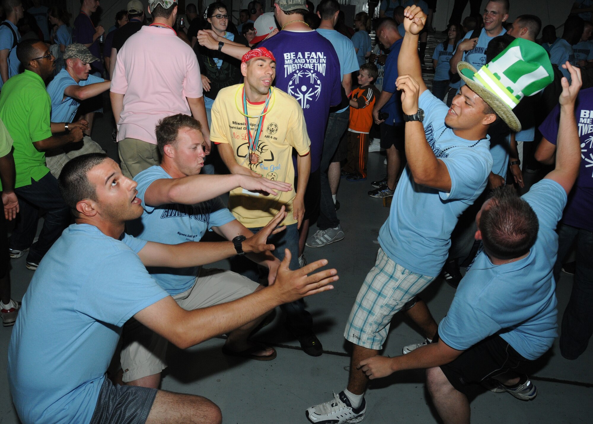 Airman Basic Luis Morello, 335th Training Squadron; Airman 1st Class Steven Tepperberg, 338 TRS; Chris Ferrell, athlete; Airman Basic Zachary Coonrod and Airman 1st Class John Heffington, 335 TRS, display a few moves during the victory dance, inside a Hangar, following closing ceremonies and ending the Special Olympics Mississippi Summer Games, May 12, 2012, at Keesler Air Force Base, Miss. It’s the 26th year that Keesler has hosted the statewide event. Opening ceremonies took place May 11. Athletic competitions took place throughout the day and were followed by a victory dance May 12. More than 1,200 athletes and coaches and 3,000 volunteers joined forces to make the event a success.  (U.S. Air Force photo by Kemberly Groue)