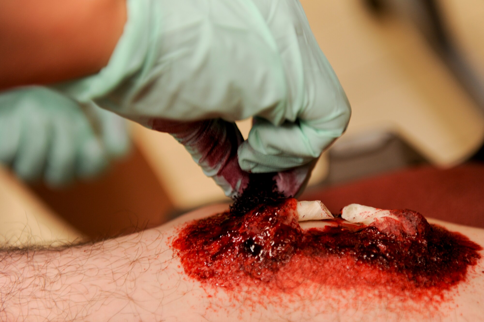 U.S. Air Force Senior Airman Kendra Fonteyne, 18th Aerospace Medicine Squadron aerospace physiology technician, uses moulage makeup to create a broken foot on a simulated victim for a self-aid and buddy care scenario during local operational readiness exercise Beverly High 12-4 on Kadena Air Base, Japan, May 16, 2012. LOREs are designed to test, train and evaluate the base's ability to respond to a contingency in the region. (U.S. Air Force photo/ Airman 1st Class Brooke P. Beers)