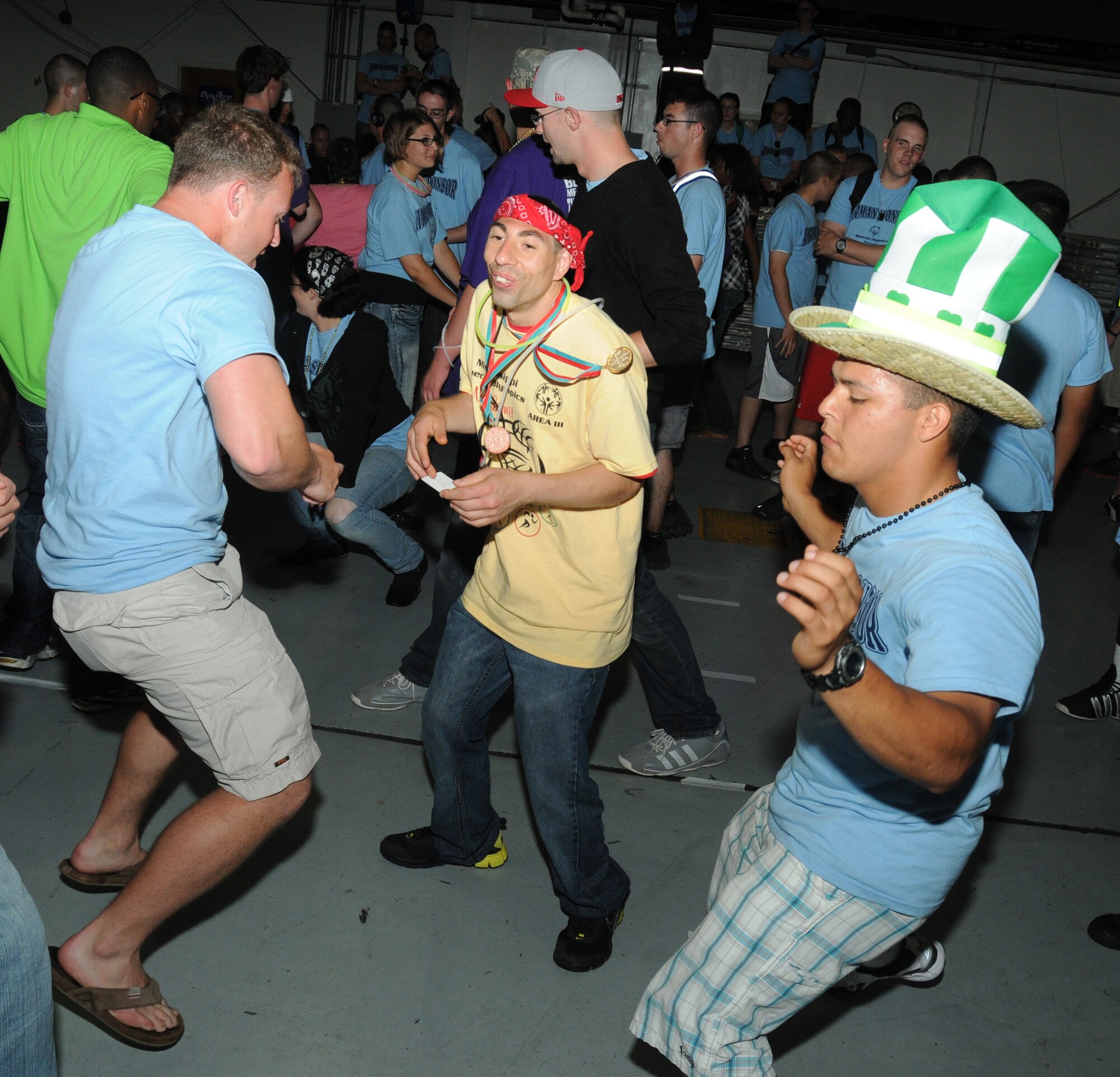 Airman 1st Class Steven Tepperberg, 338th Training Squadron; Chris Ferrell, athlete; and Airman Basic Zachary Coonrod, 335 TRS, display a few moves during the victory dance, inside a Hangar, following closing ceremonies and ending the Special Olympics Mississippi Summer Games, May 12, 2012, at Keesler Air Force Base, Miss. It’s the 26th year that Keesler has hosted the statewide event. Opening ceremonies took place May 11. Athletic competitions took place throughout the day and were followed by a victory dance May 12. More than 1,200 athletes and coaches and 3,000 volunteers joined forces to make the event a success.  (U.S. Air Force photo by Kemberly Groue)